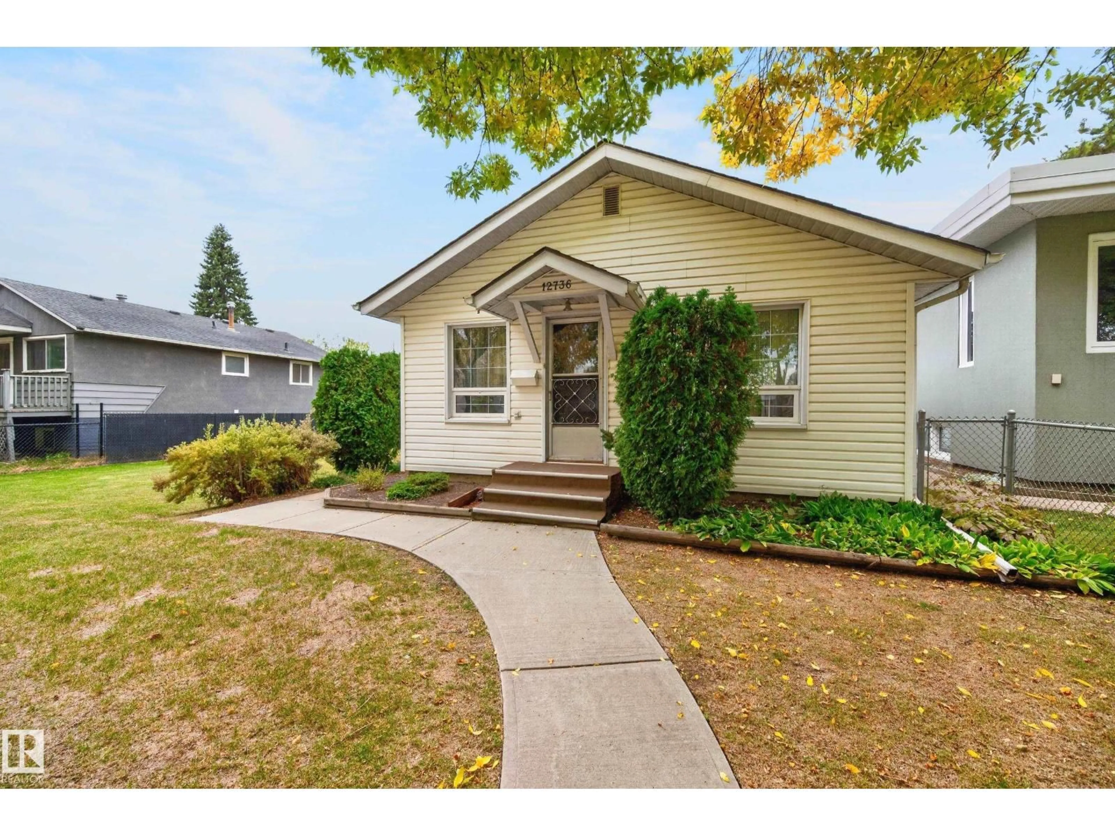 Home with vinyl exterior material, street for 12736 116 ST, Edmonton Alberta T5E5H2