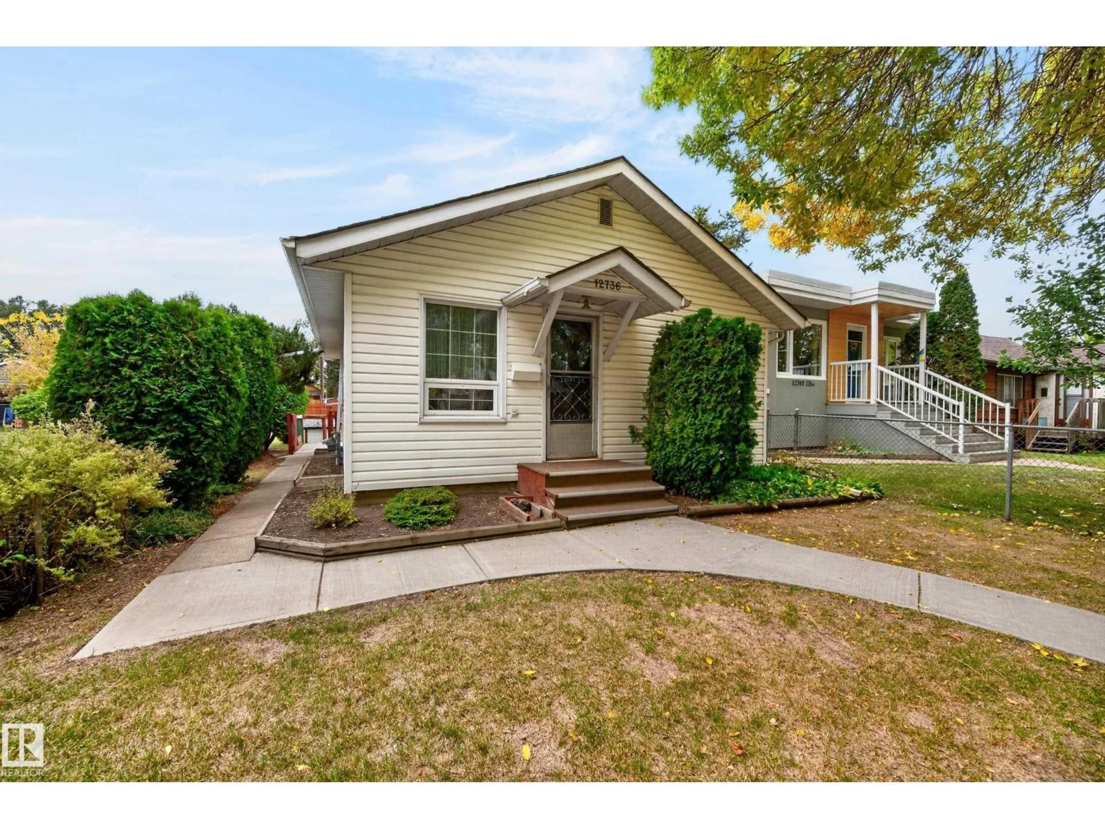 Home with vinyl exterior material, street for 12736 116 ST, Edmonton Alberta T5E5H2