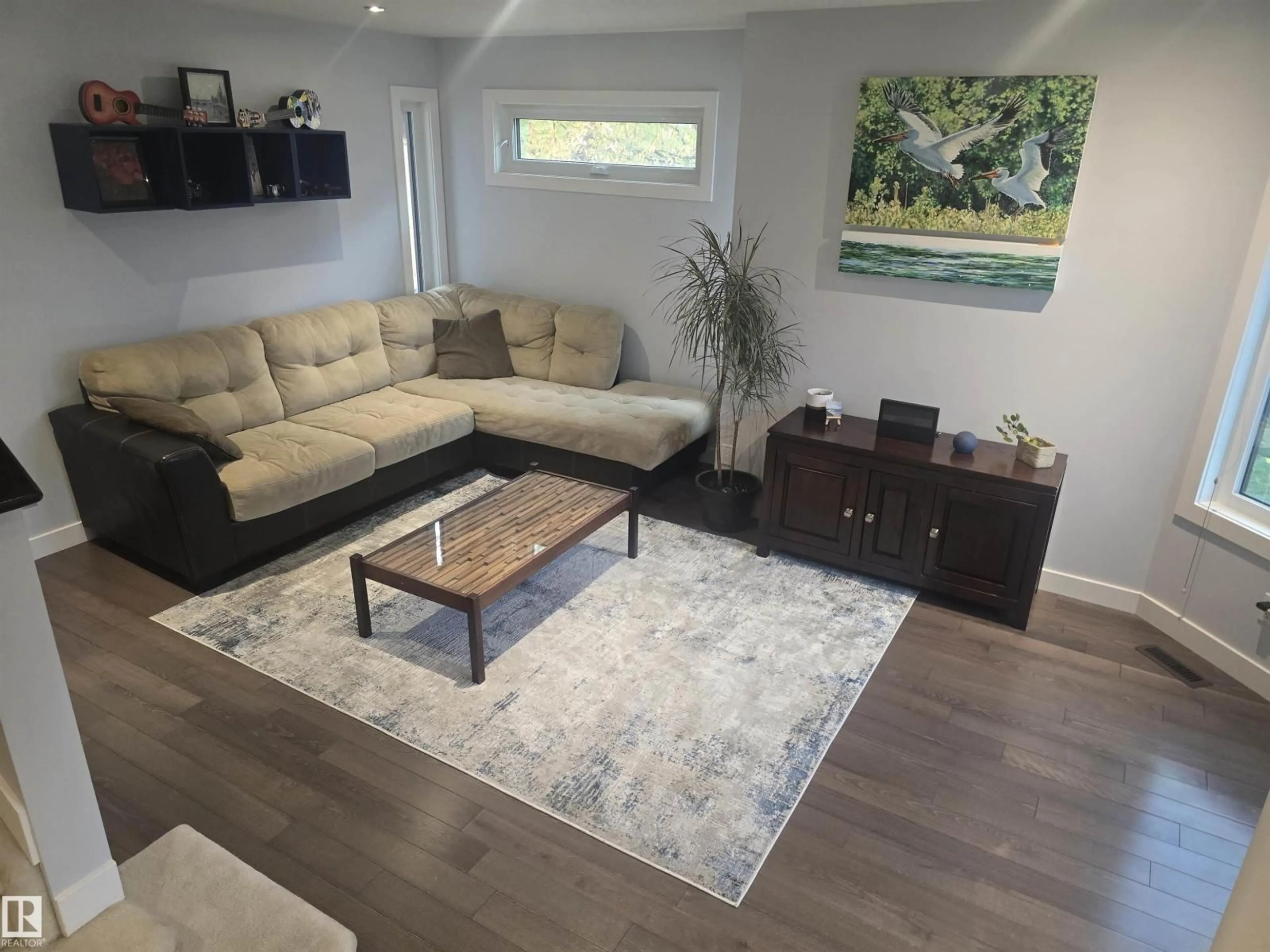 Living room with furniture, wood/laminate floor for NW - 3659 30 ST, Edmonton Alberta T6T1K3