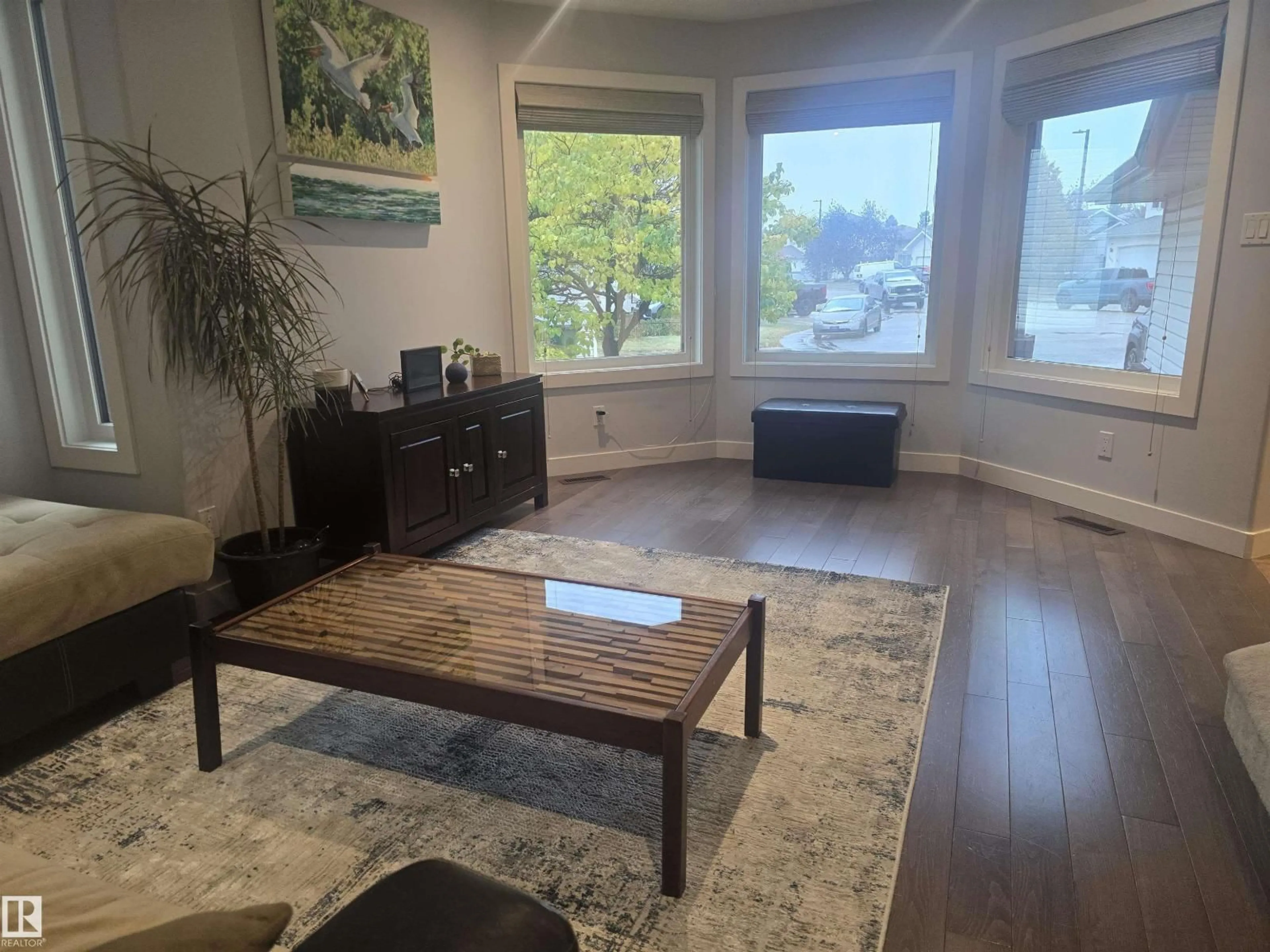 Living room with furniture, wood/laminate floor for NW - 3659 30 ST, Edmonton Alberta T6T1K3
