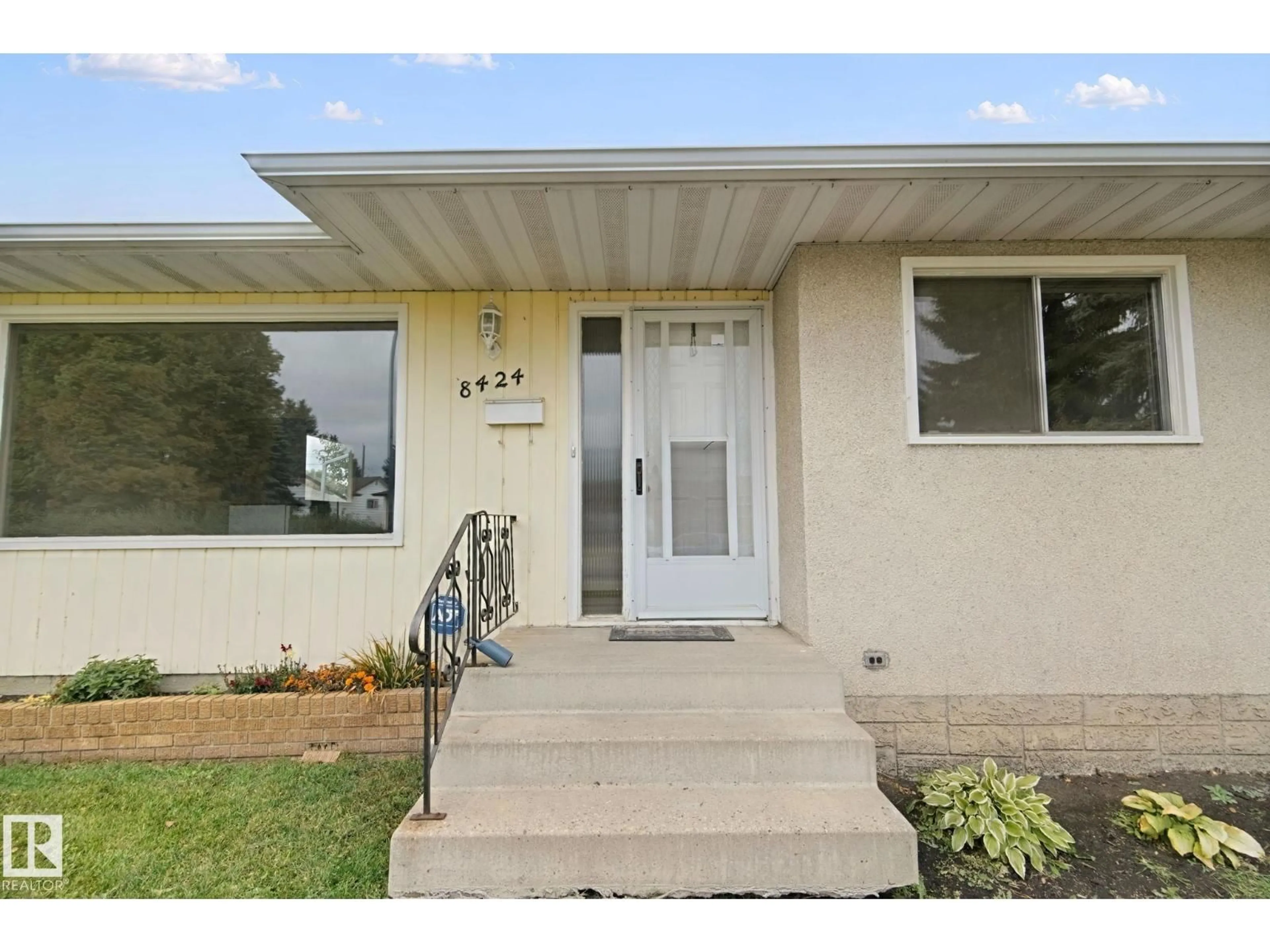 Home with vinyl exterior material, street for NW - 8424 70 ST, Edmonton Alberta T6B1W5
