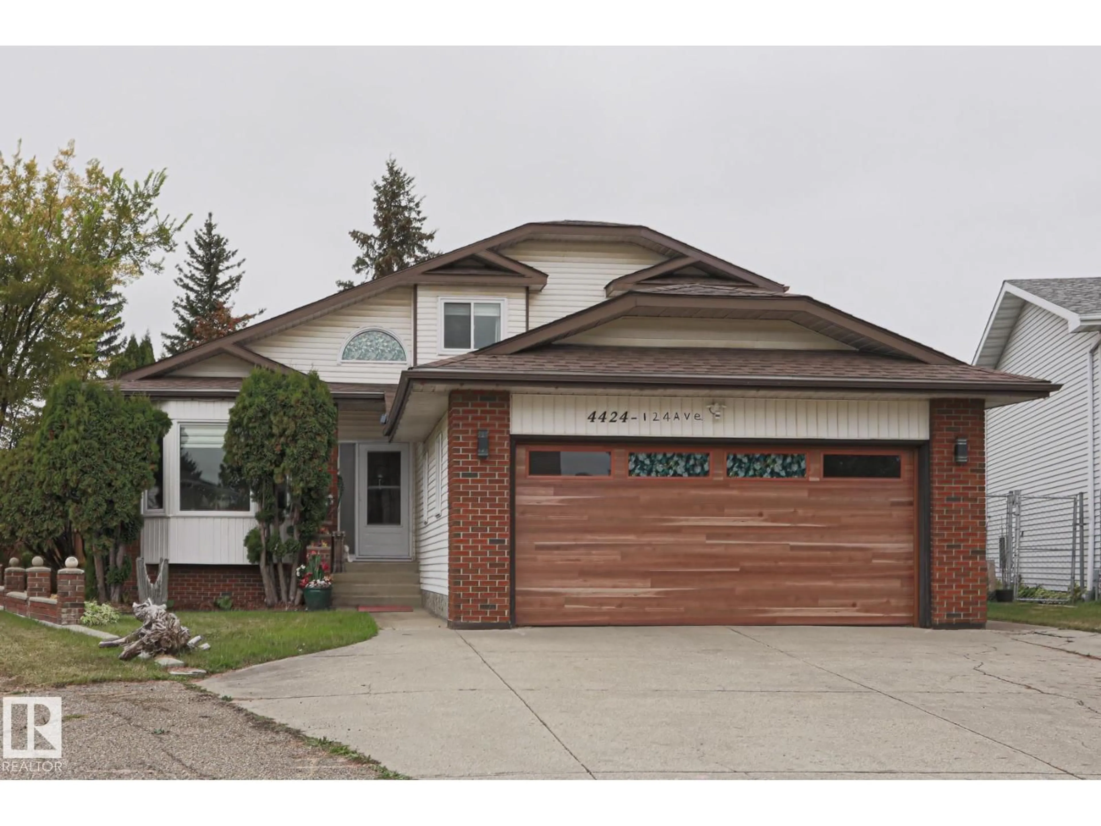 Home with vinyl exterior material, street for NW - 4424 124 AV, Edmonton Alberta T5W5B9