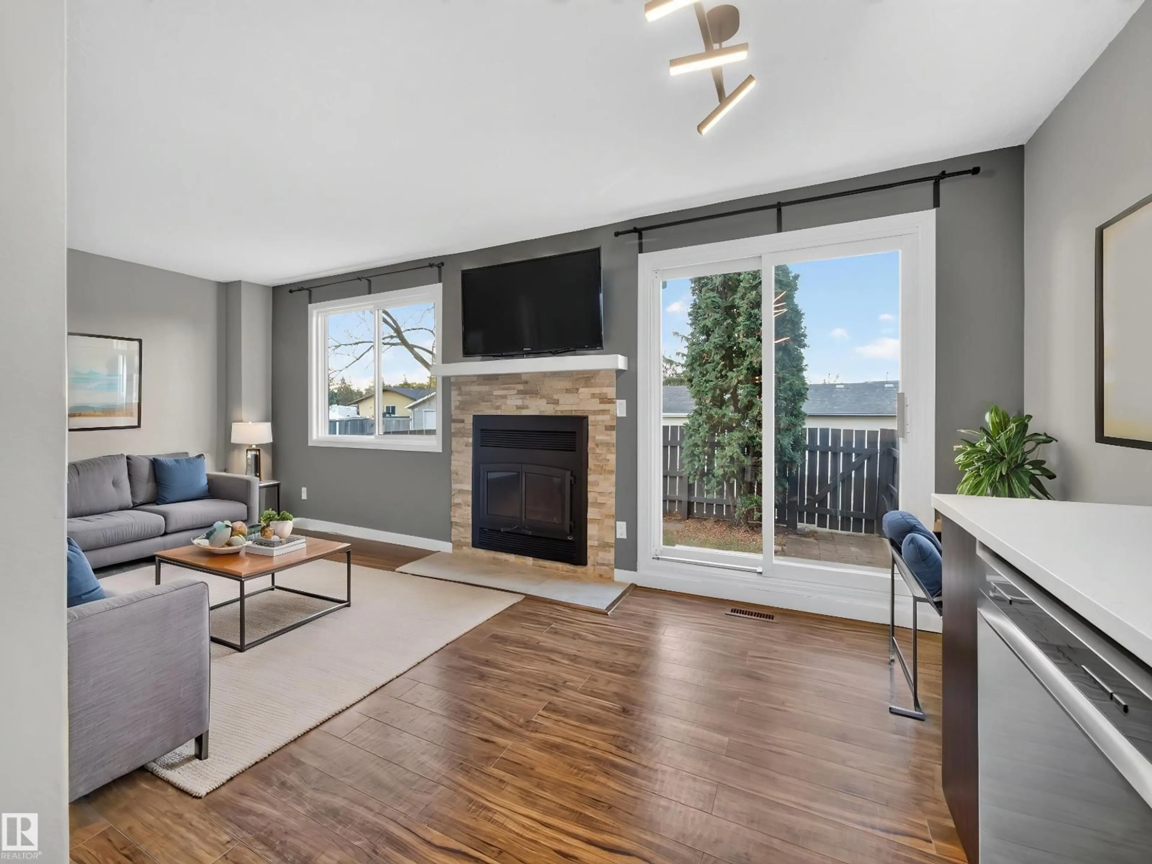 Living room with furniture, wood/laminate floor for 1514A 69 ST, Edmonton Alberta T6K3R3