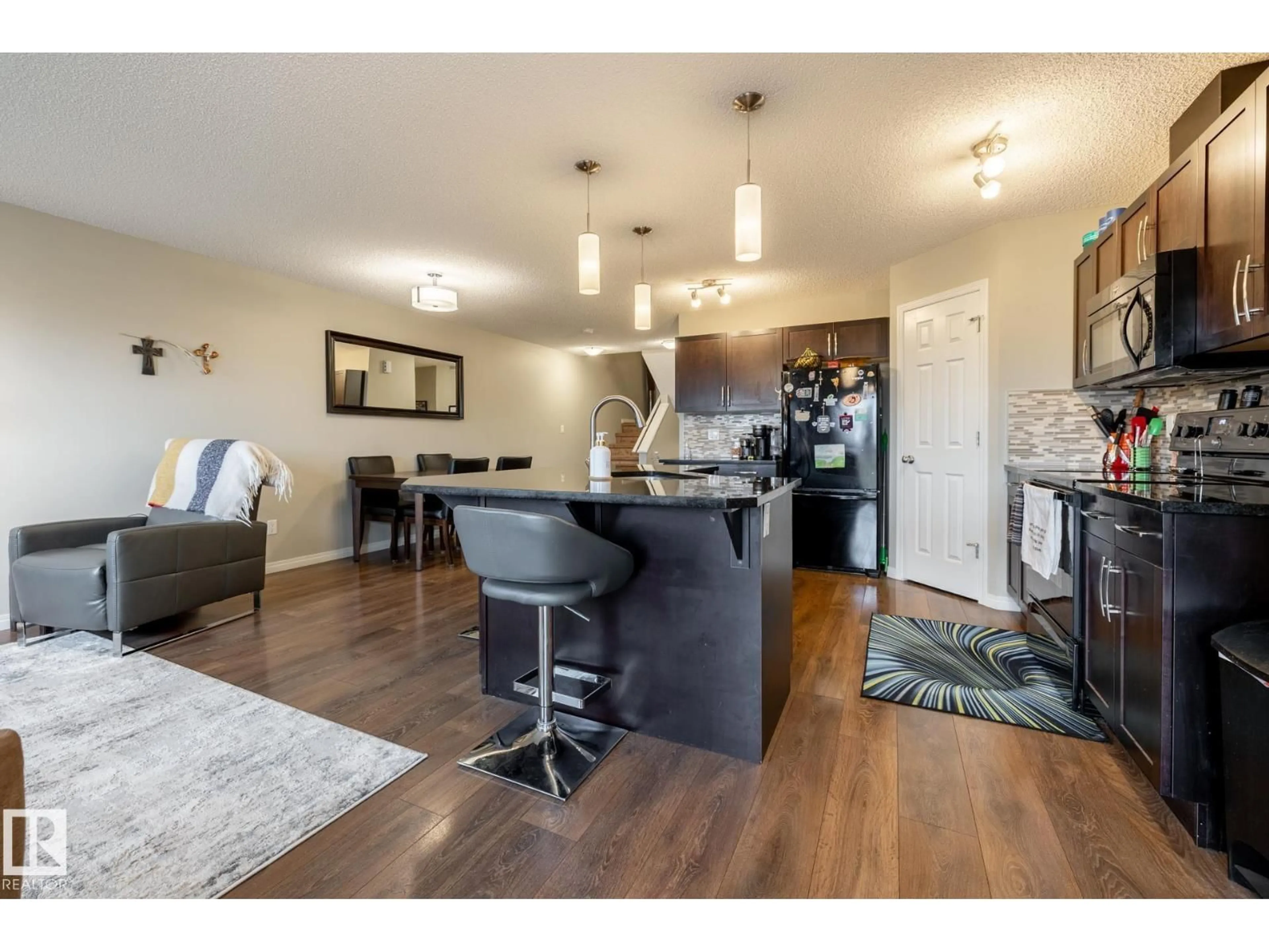 Open concept kitchen, wood/laminate floor for 2093 CHALMERS WY, Edmonton Alberta T6W2E9