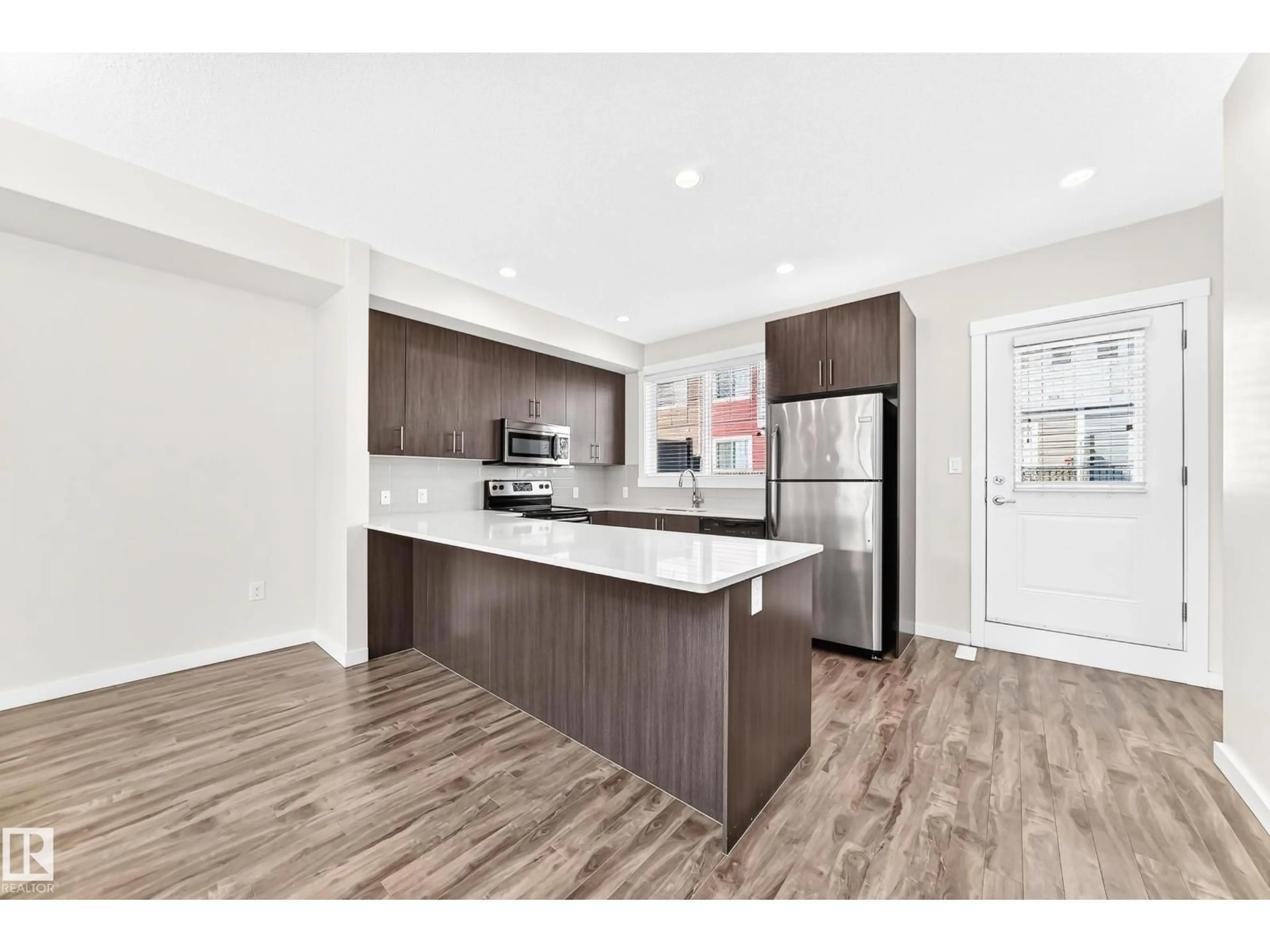 Open concept kitchen, wood/laminate floor for 903 - 56 CRYSTALLINA NERA WY, Edmonton Alberta T5Z0N6