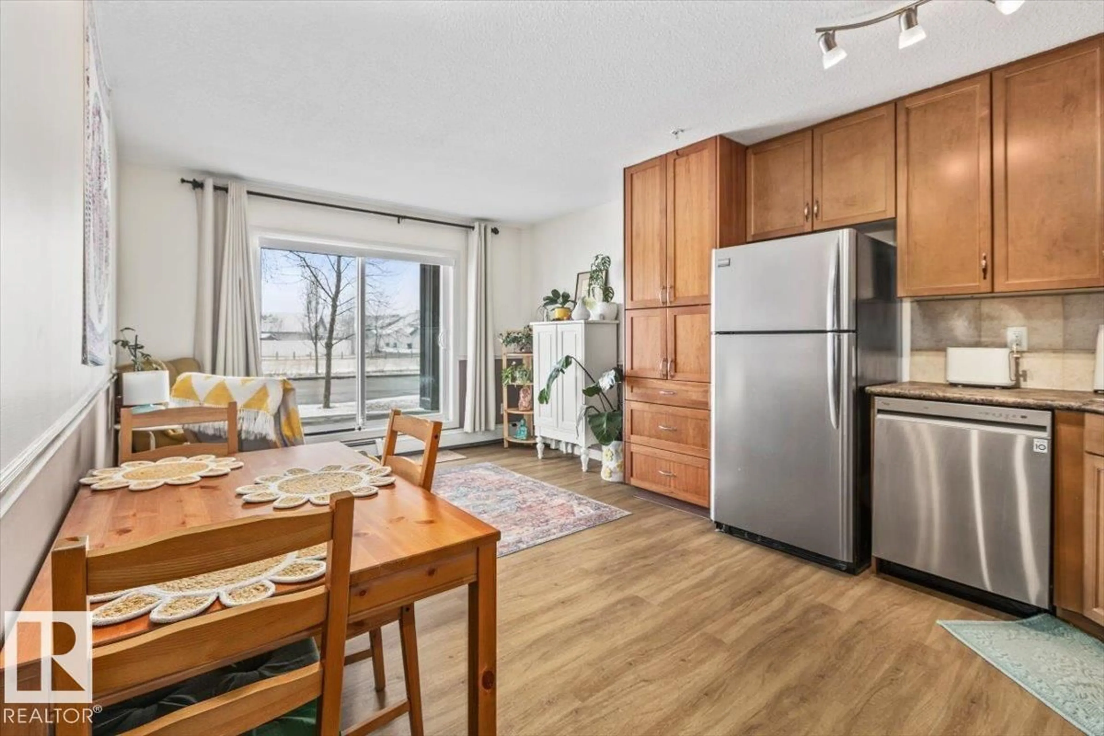 Open concept kitchen, wood/laminate floor for #106 - 1204 156 ST, Edmonton Alberta T6R0R6