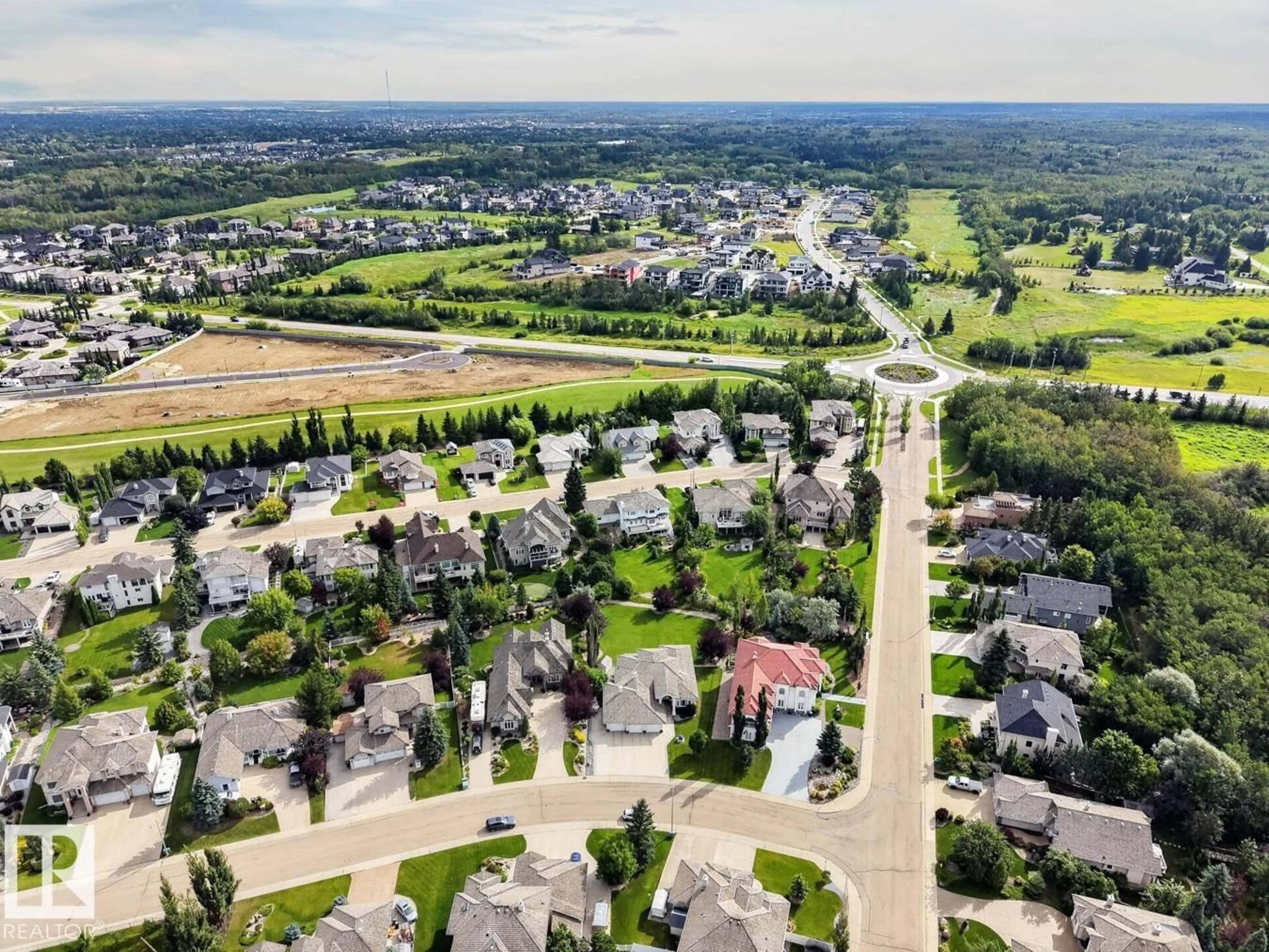 A pic from outside/outdoor area/front of a property/back of a property/a pic from drone, street for #203 - 52304 RGE ROAD 233, Rural Strathcona County Alberta T8B1C9