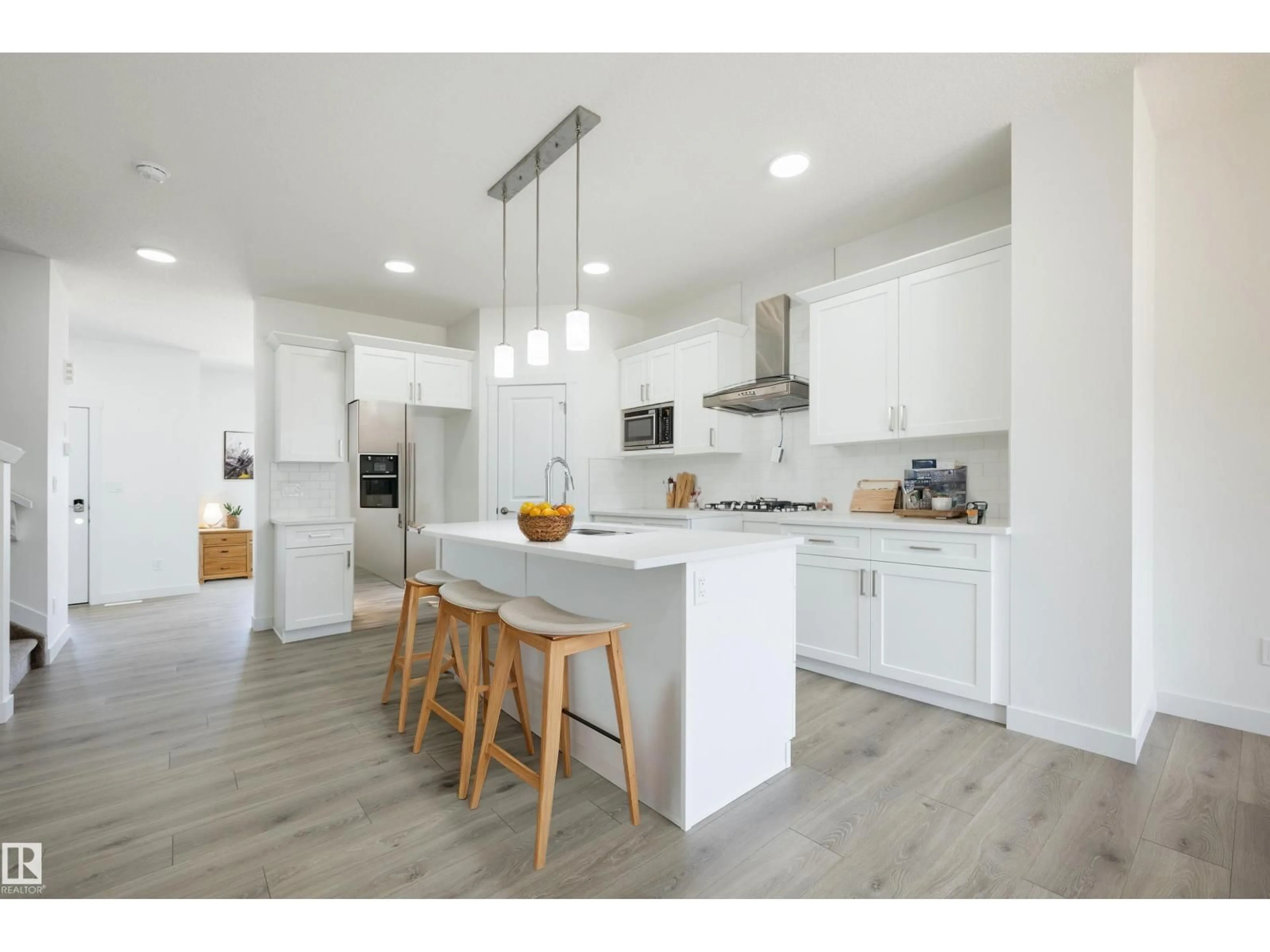 Open concept kitchen, wood/laminate floor for 614 ASHGROVE CI, Leduc Alberta T9E1X4