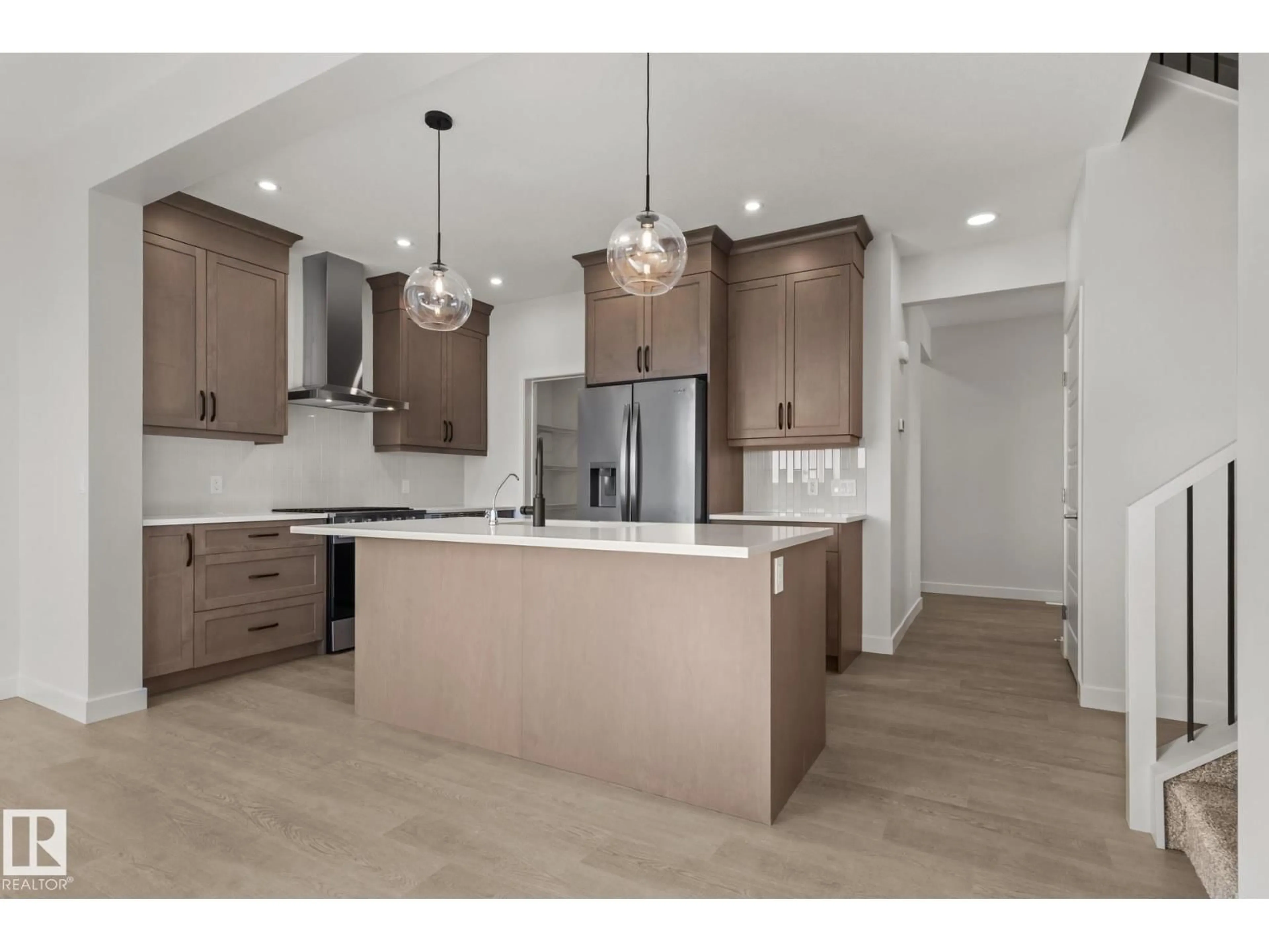 Open concept kitchen, wood/laminate floor for 2503 MUCKLEPLUM CO, Edmonton Alberta T6X3K1