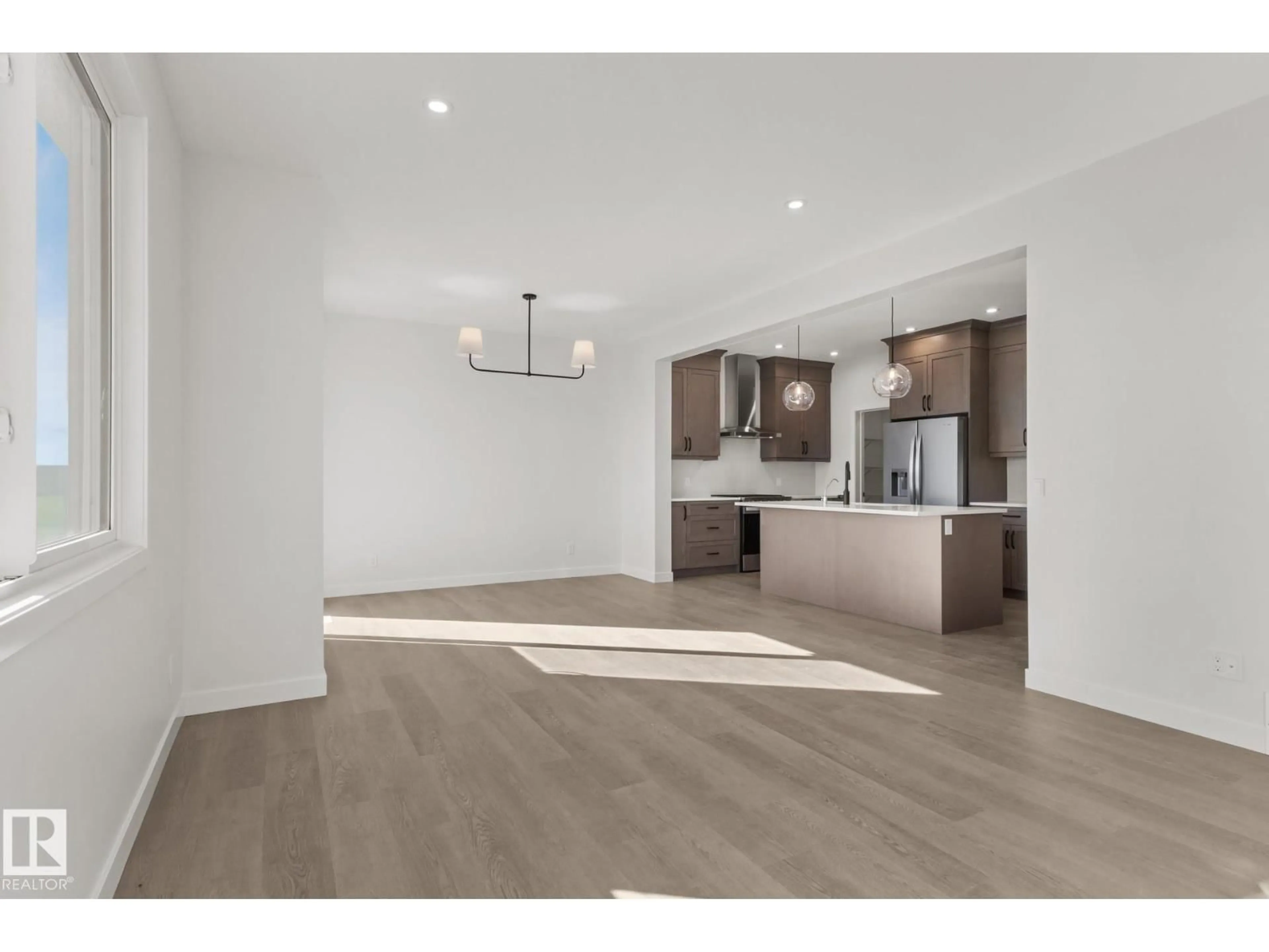 Open concept kitchen, wood/laminate floor for 2503 MUCKLEPLUM CO, Edmonton Alberta T6X3K1