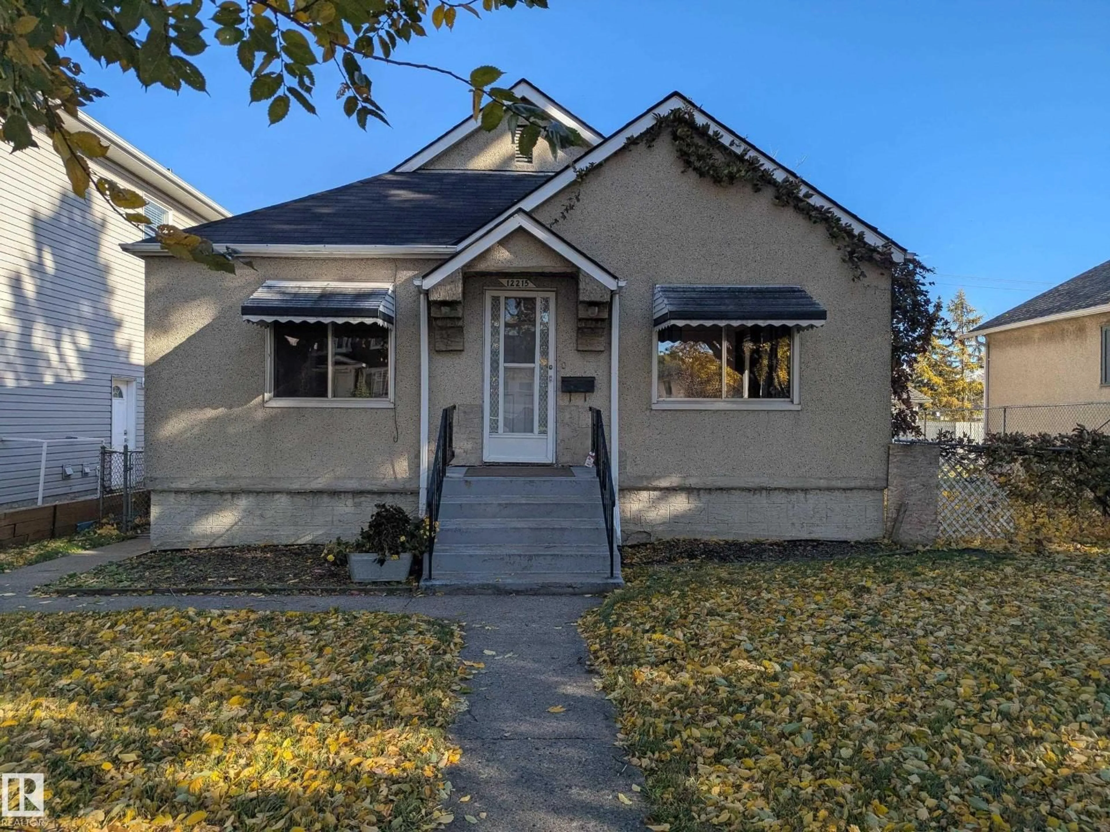 Home with vinyl exterior material, street for NW - 12215 101 ST, Edmonton Alberta T5G2C5