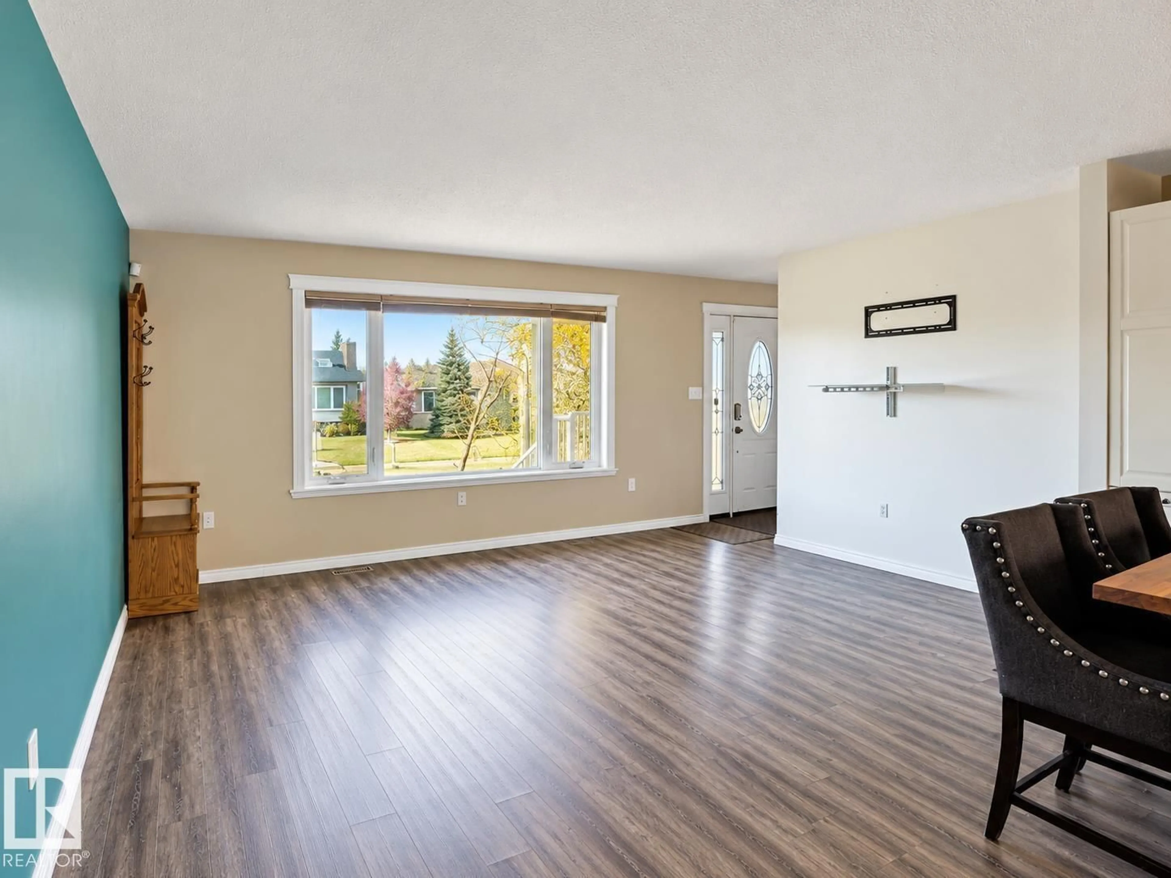Living room with furniture, wood/laminate floor for 5919 53 AVE, Vermilion Alberta T9X1M1