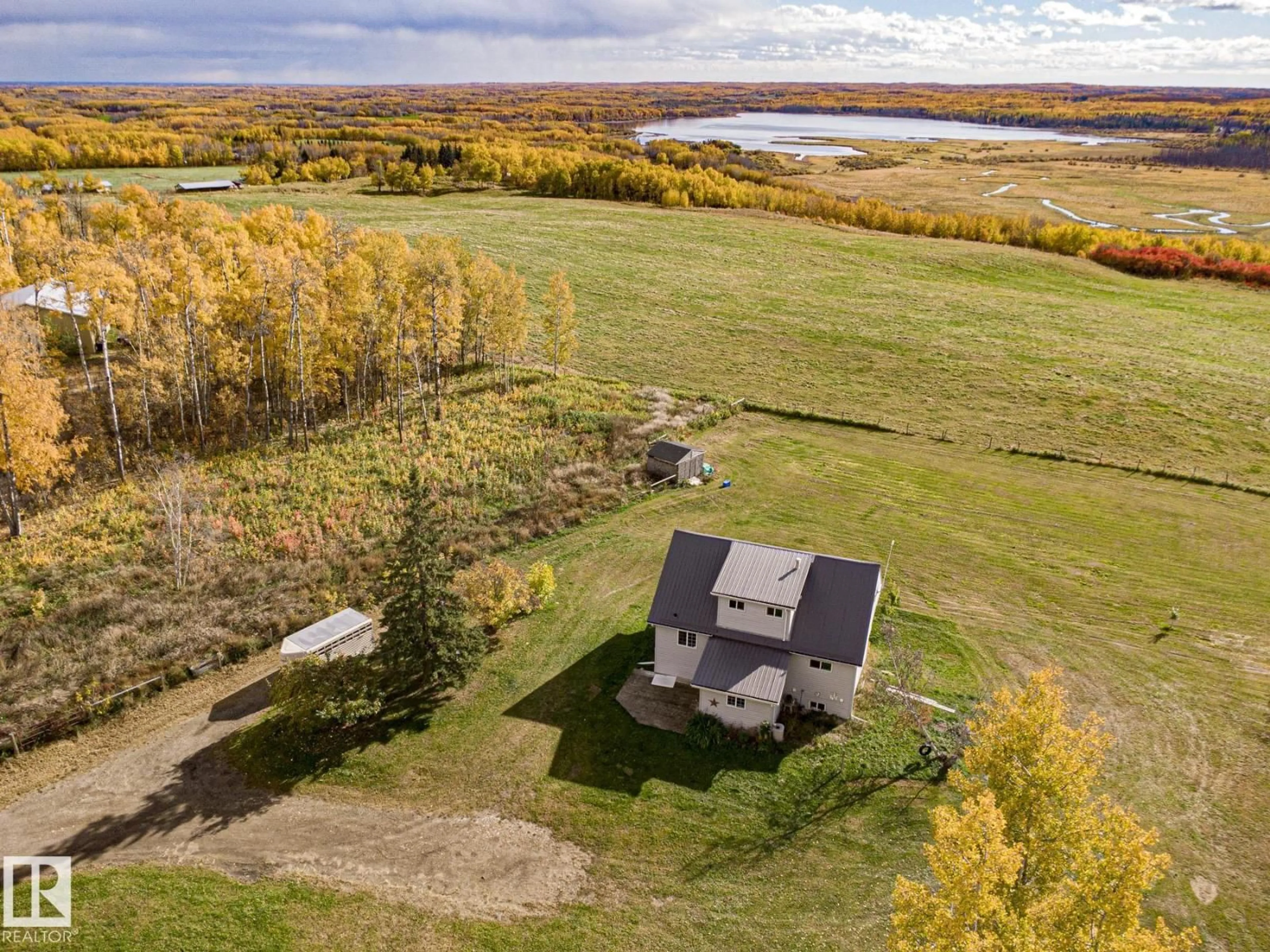A pic from outside/outdoor area/front of a property/back of a property/a pic from drone, water/lake/river/ocean view for #203 - 1414 HWY 37, Rural Lac Ste. Anne County Alberta T0E1V0