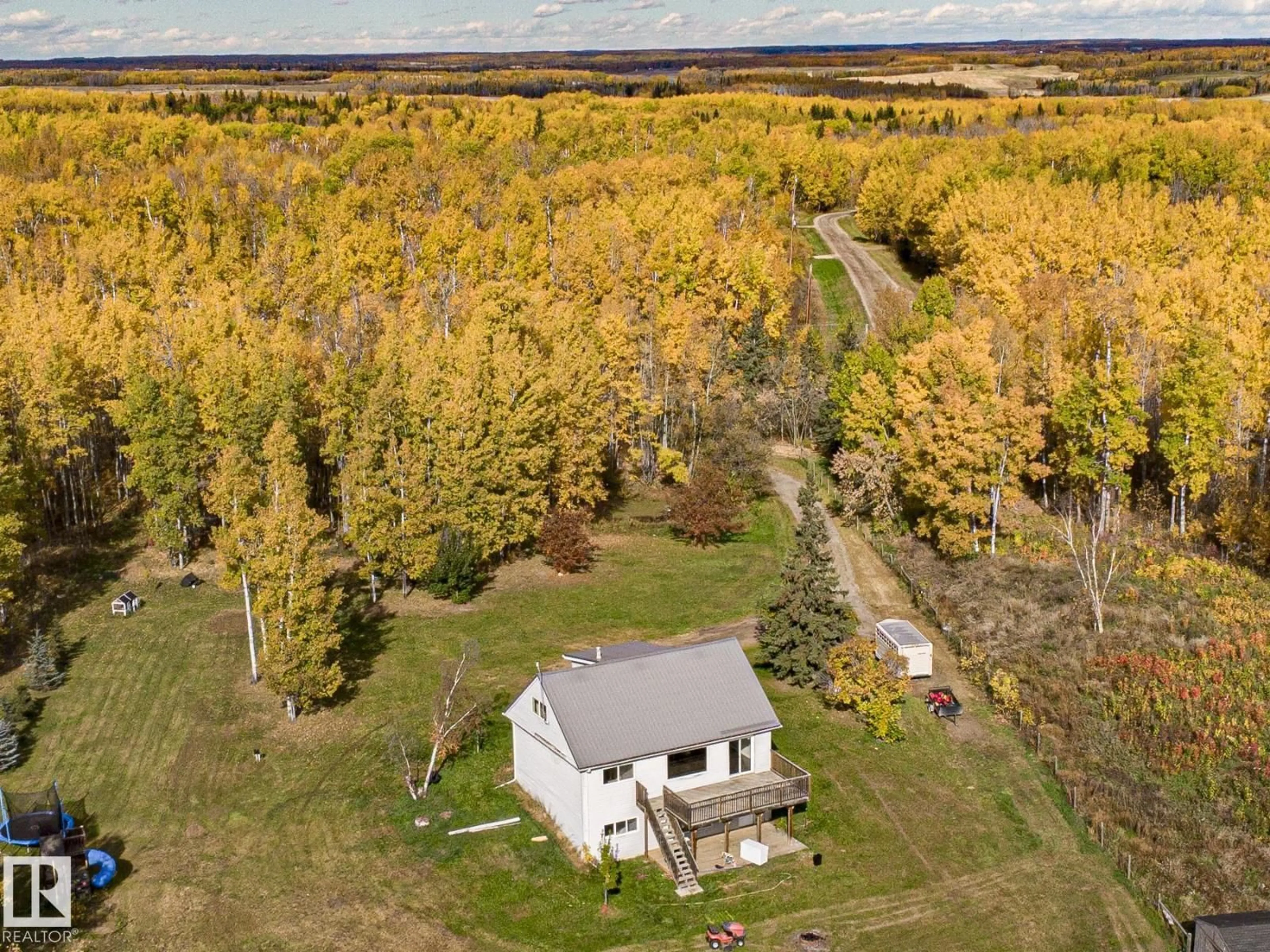 A pic from outside/outdoor area/front of a property/back of a property/a pic from drone, forest/trees view for #203 - 1414 HWY 37, Rural Lac Ste. Anne County Alberta T0E1V0