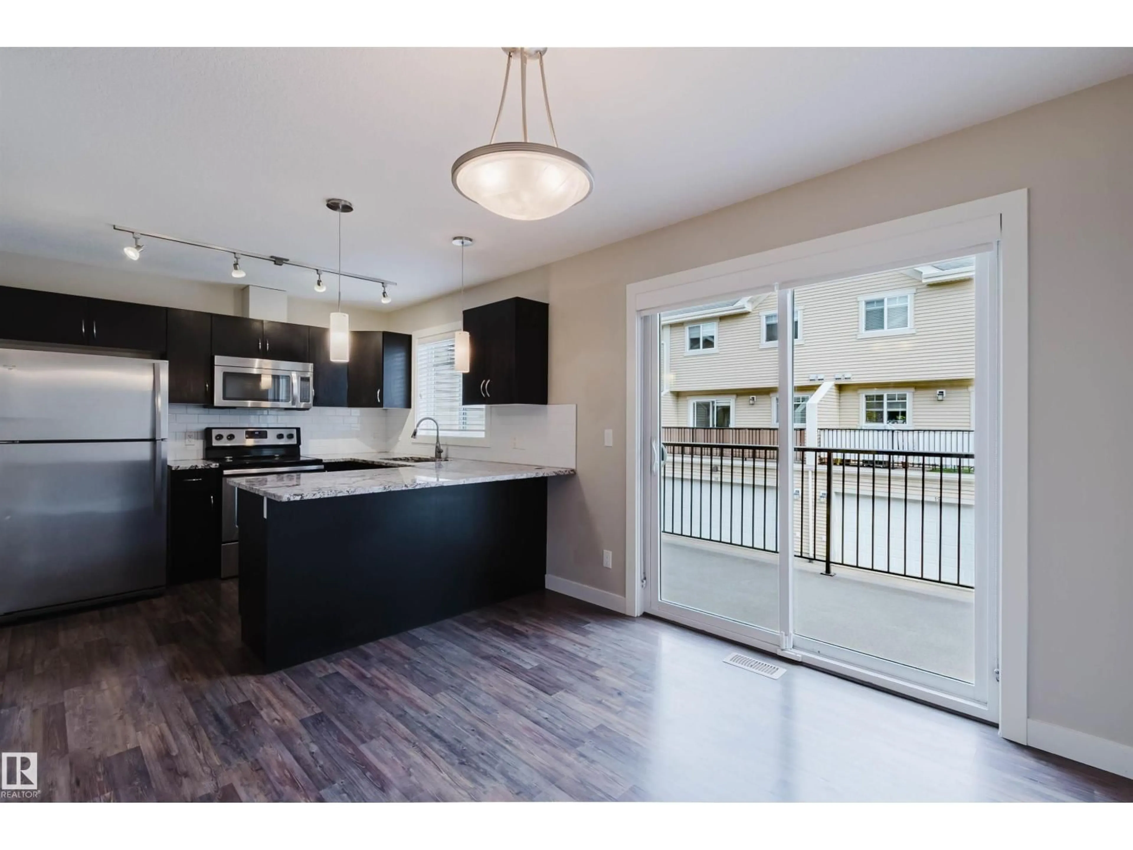 Open concept kitchen, wood/laminate floor for #31 - 7289 SOUTH TERWILLEGAR DR, Edmonton Alberta T6R0N5