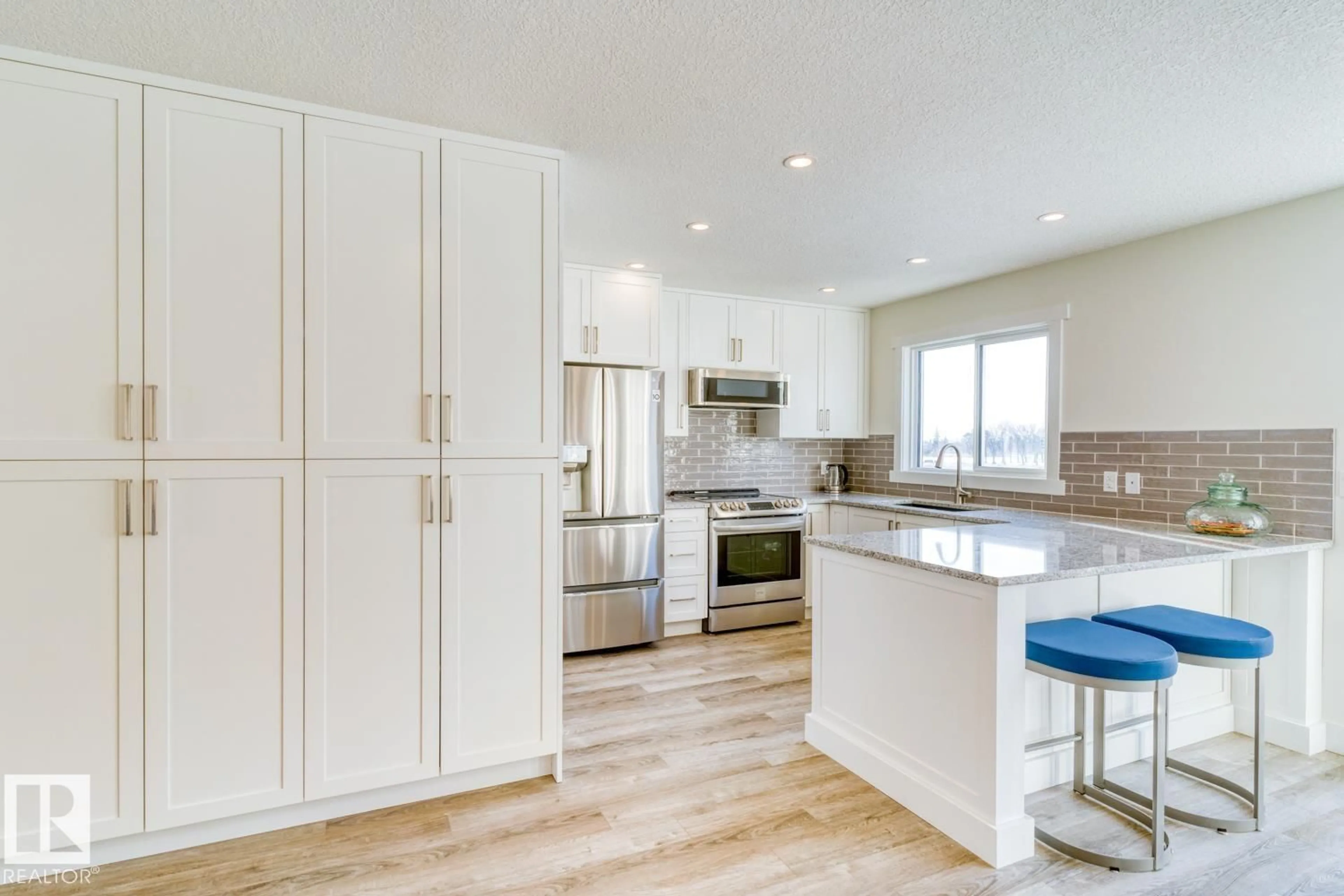 Open concept kitchen, wood/laminate floor for 9250 156 AV, Edmonton Alberta T5Z3N7