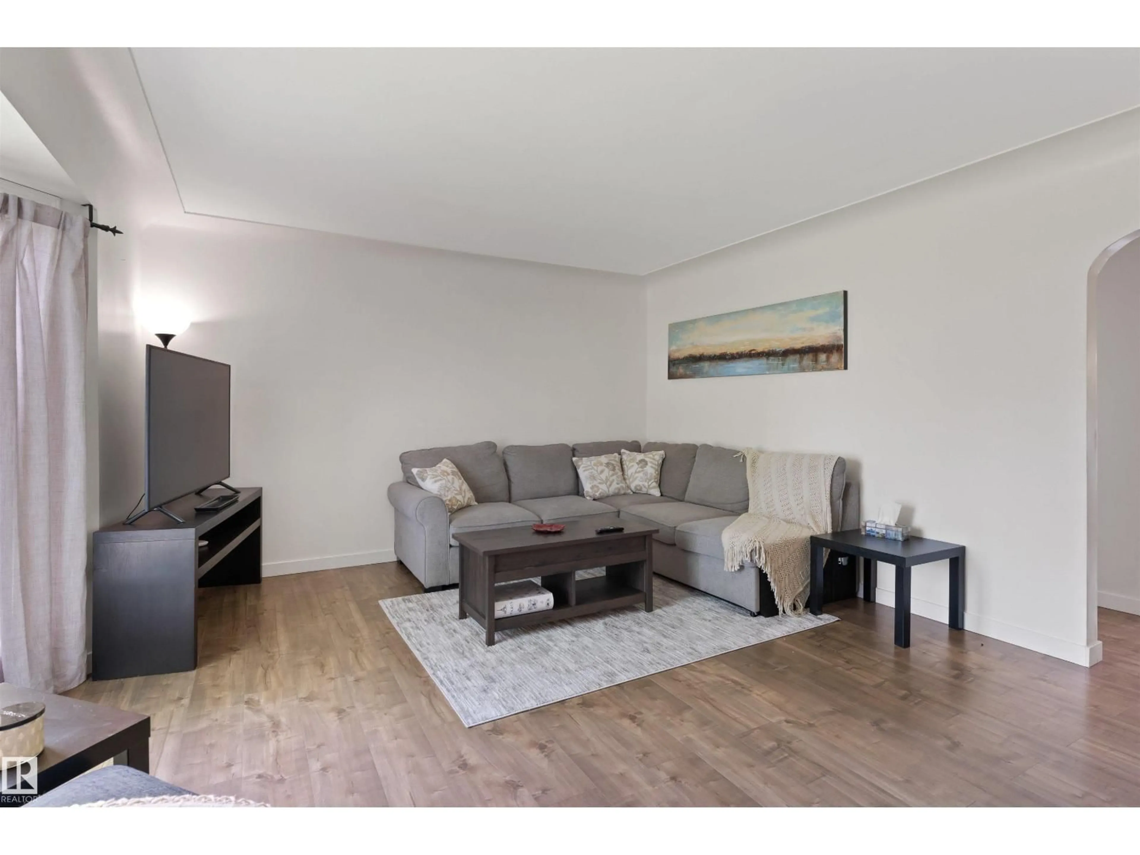 Living room with furniture, wood/laminate floor for 10994 135 ST, Edmonton Alberta T5M1K2