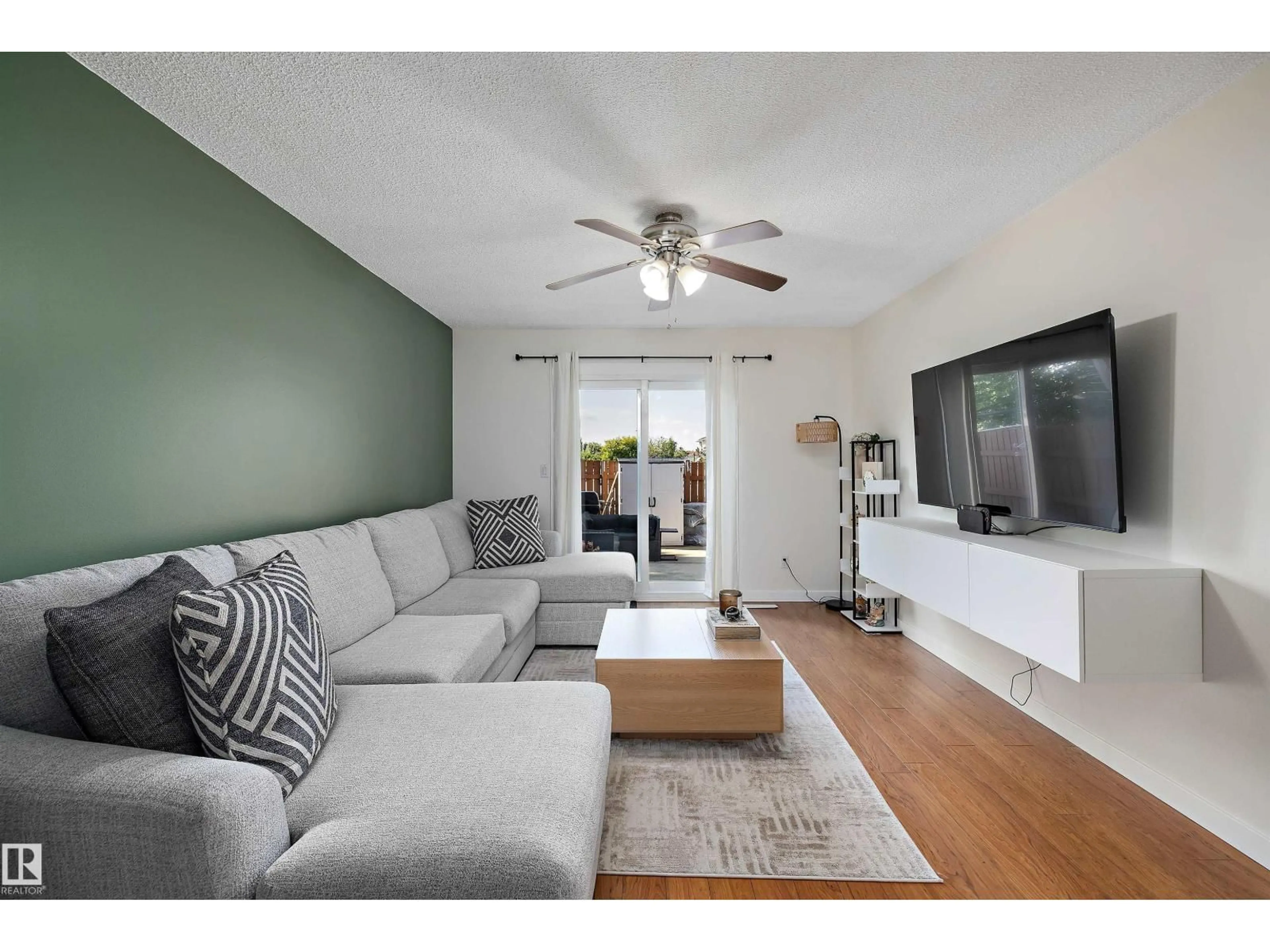 Living room with furniture, wood/laminate floor for NW - 14207 23 ST, Edmonton Alberta T5Y1N1
