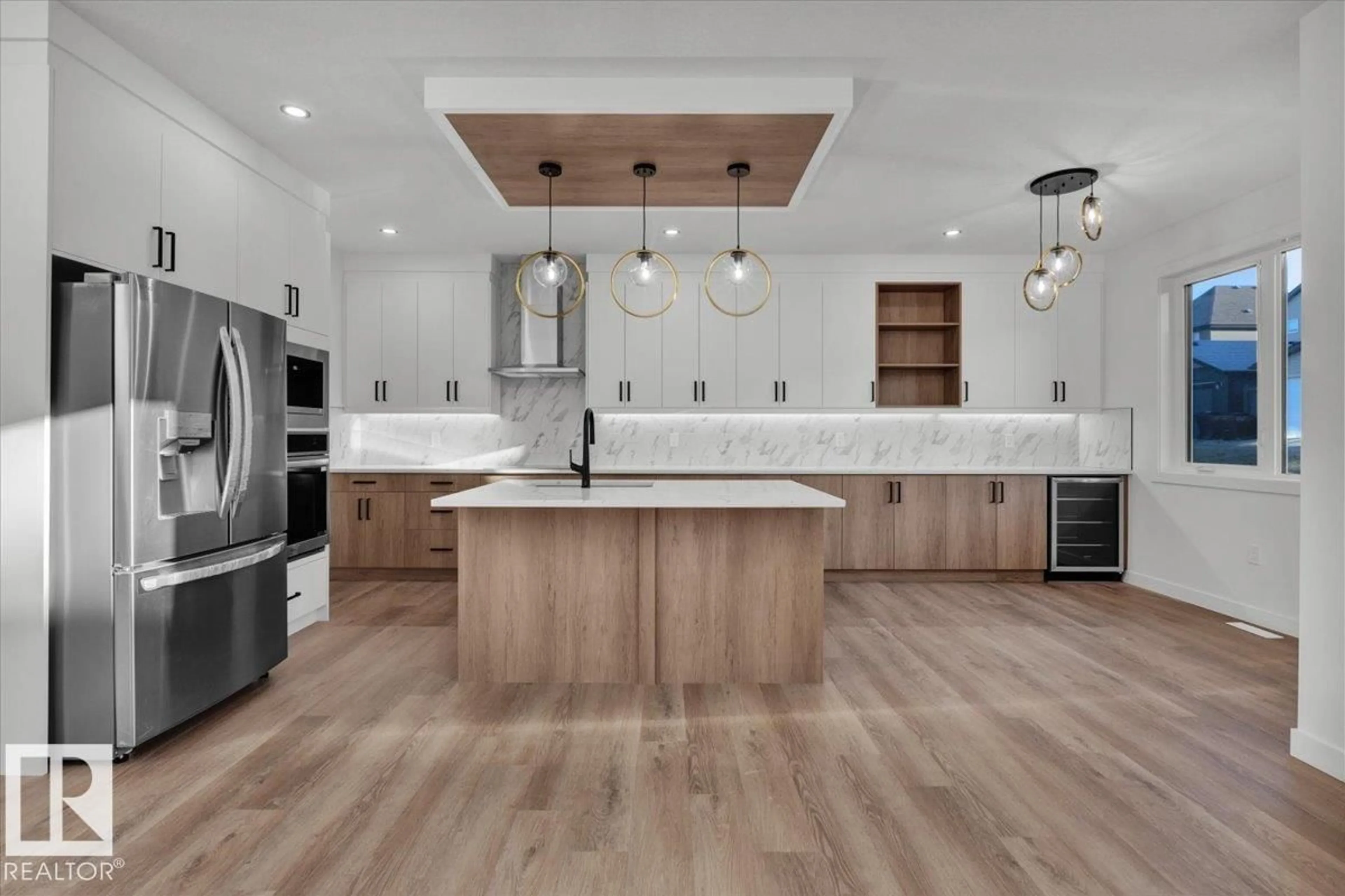 Open concept kitchen, wood/laminate floor for 1115 GYRFALCON CR, Edmonton Alberta T5S0S1