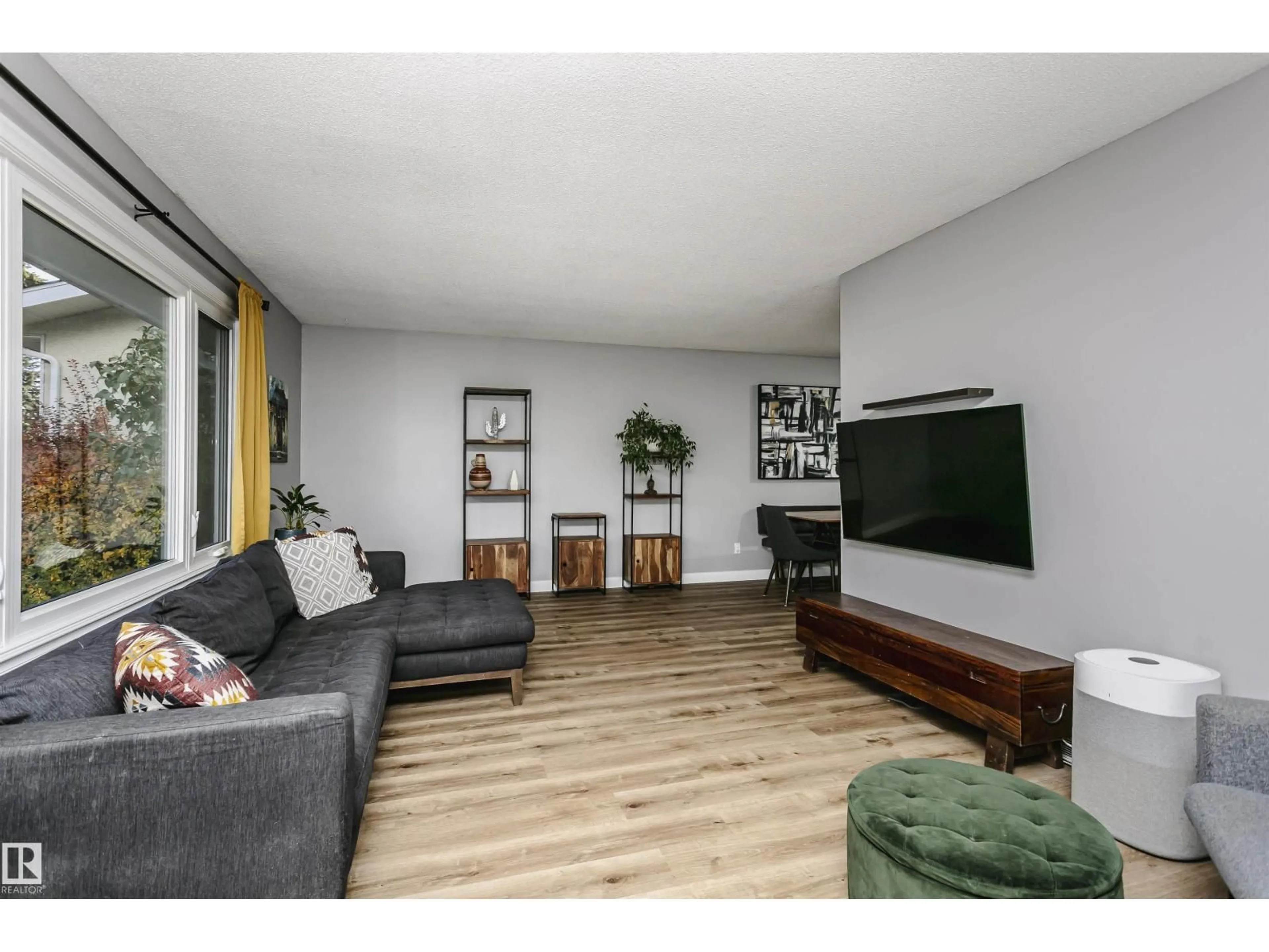 Living room with furniture, wood/laminate floor for 10435 35A AV, Edmonton Alberta T6J2H1
