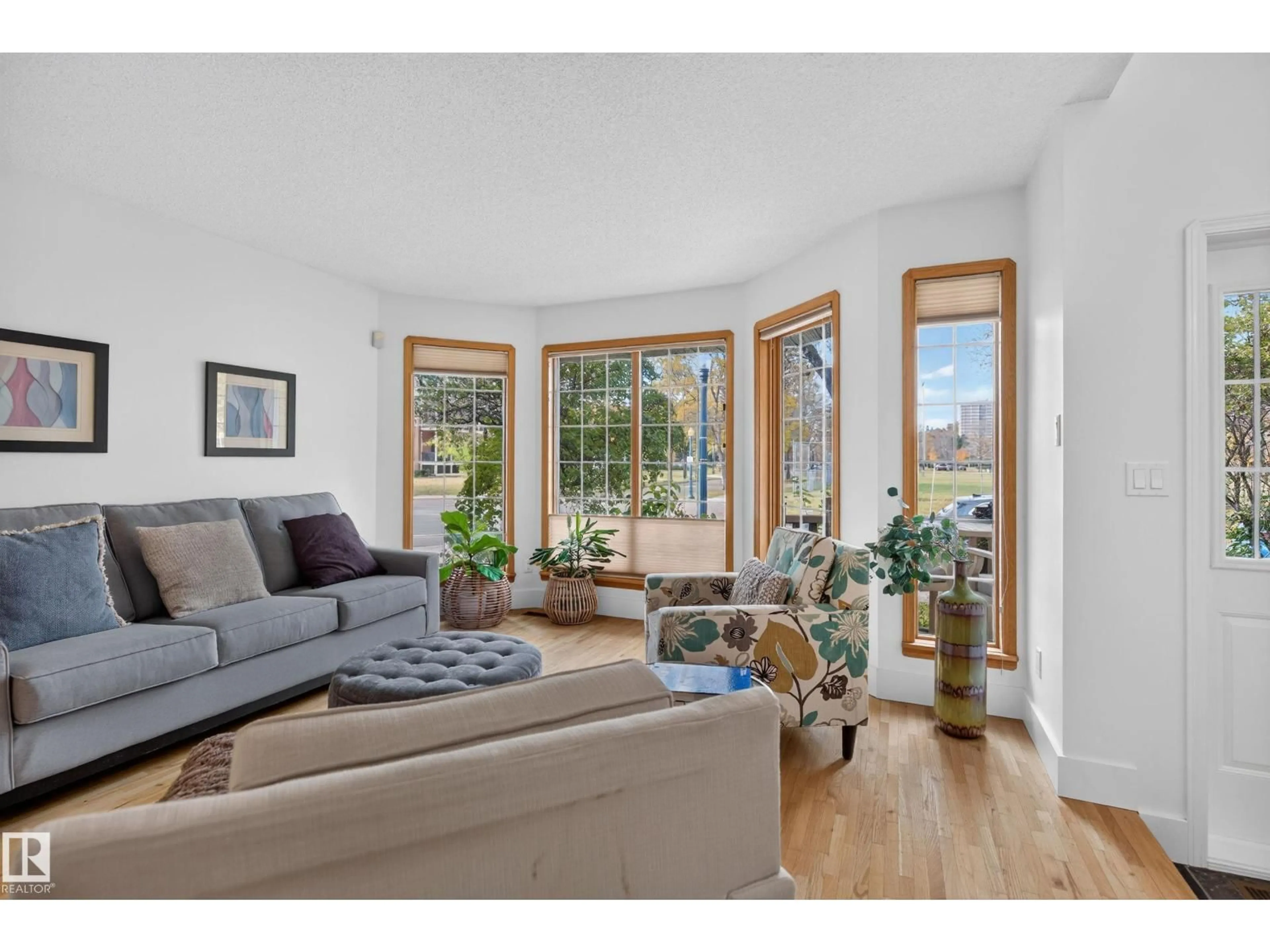 Living room with furniture, wood/laminate floor for NW - 9601 101 ST, Edmonton Alberta T5K0W7