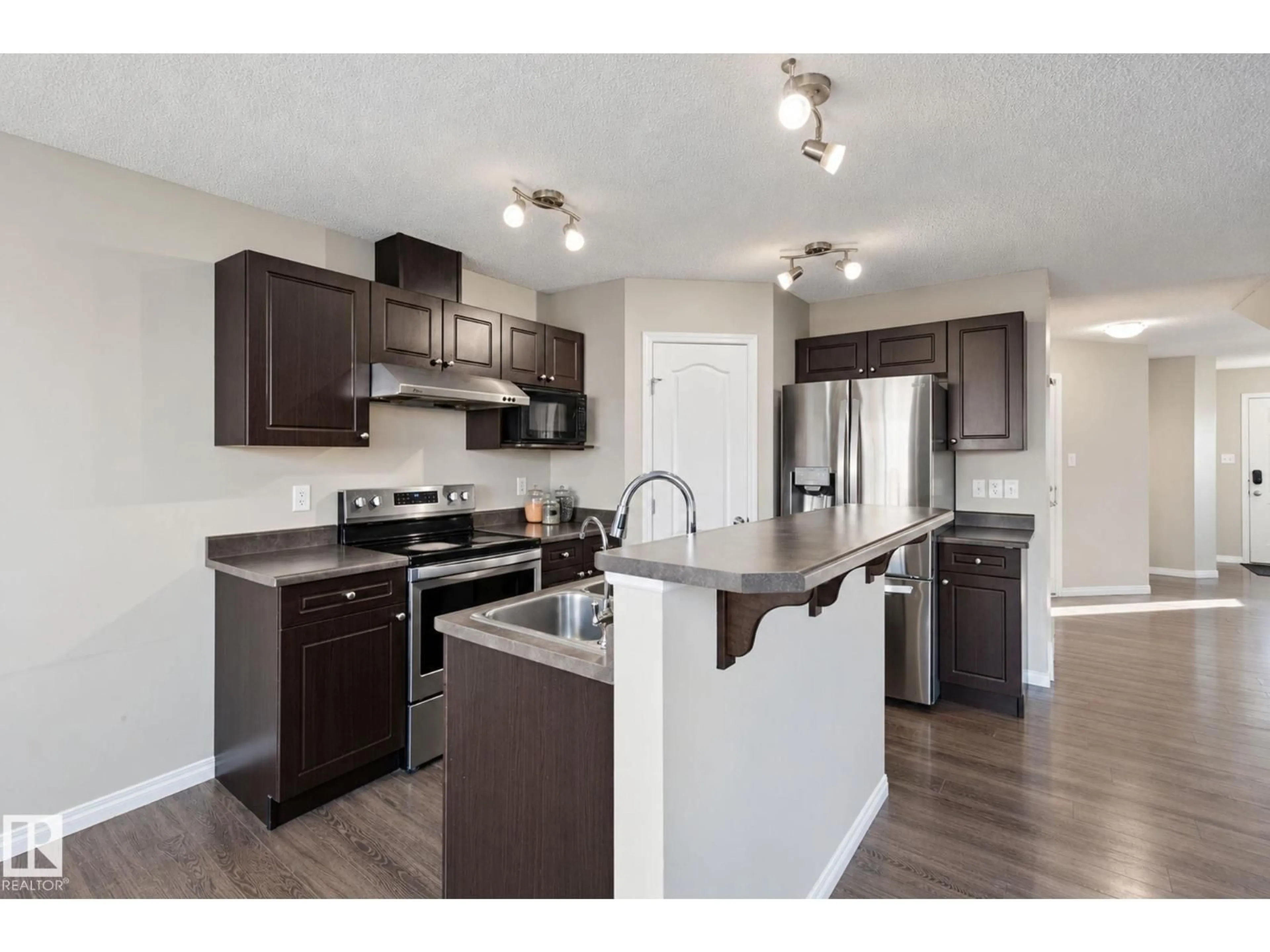Open concept kitchen, wood/laminate floor for 3026 16A AV, Edmonton Alberta T6T0P8
