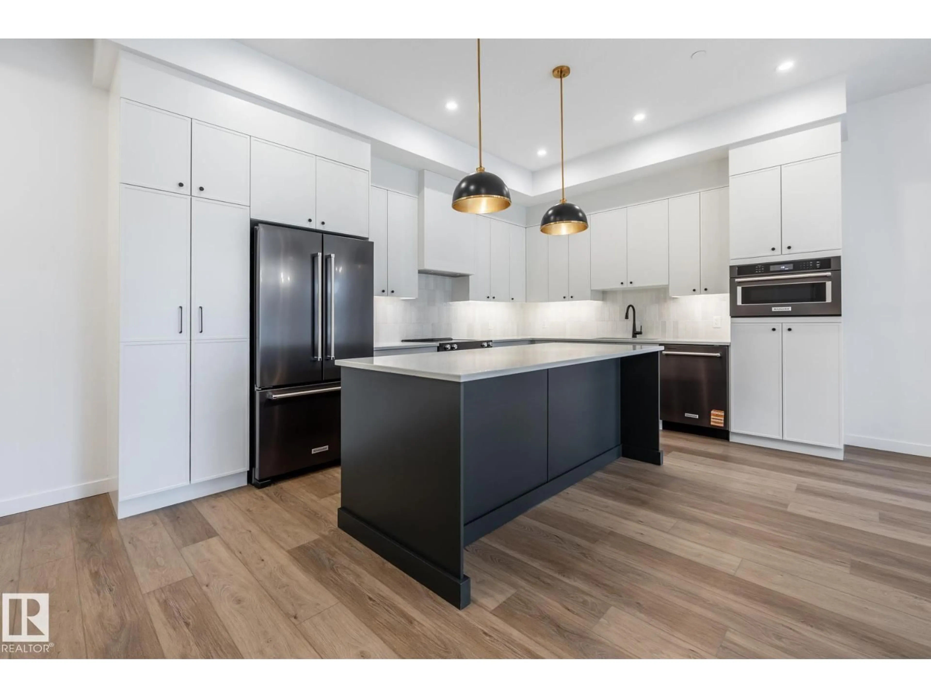 Open concept kitchen, wood/laminate floor for #104 - 7459 MAY COMMON, Edmonton Alberta T6R0X6