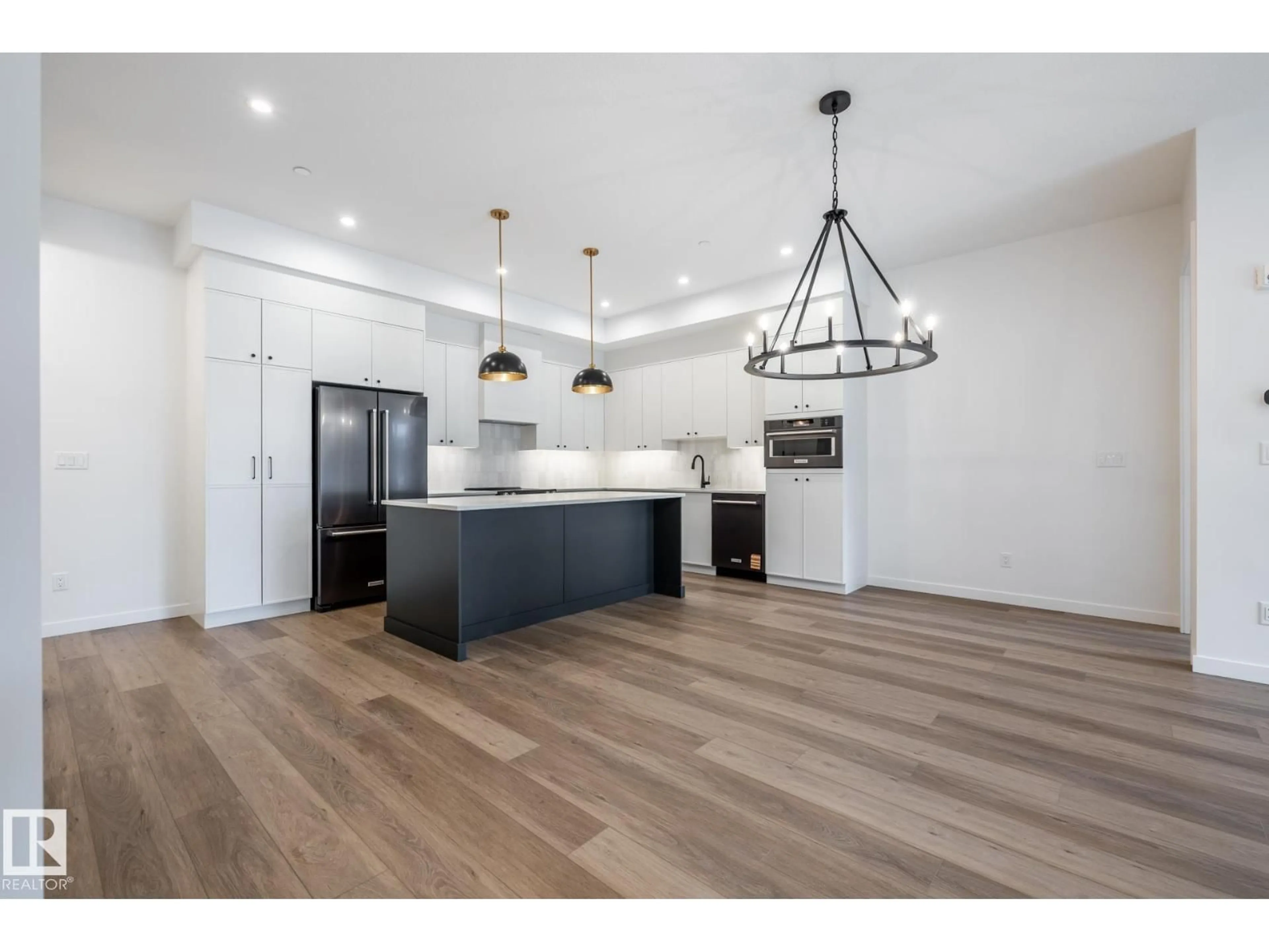 Open concept kitchen, wood/laminate floor for #104 - 7459 MAY COMMON, Edmonton Alberta T6R0X6