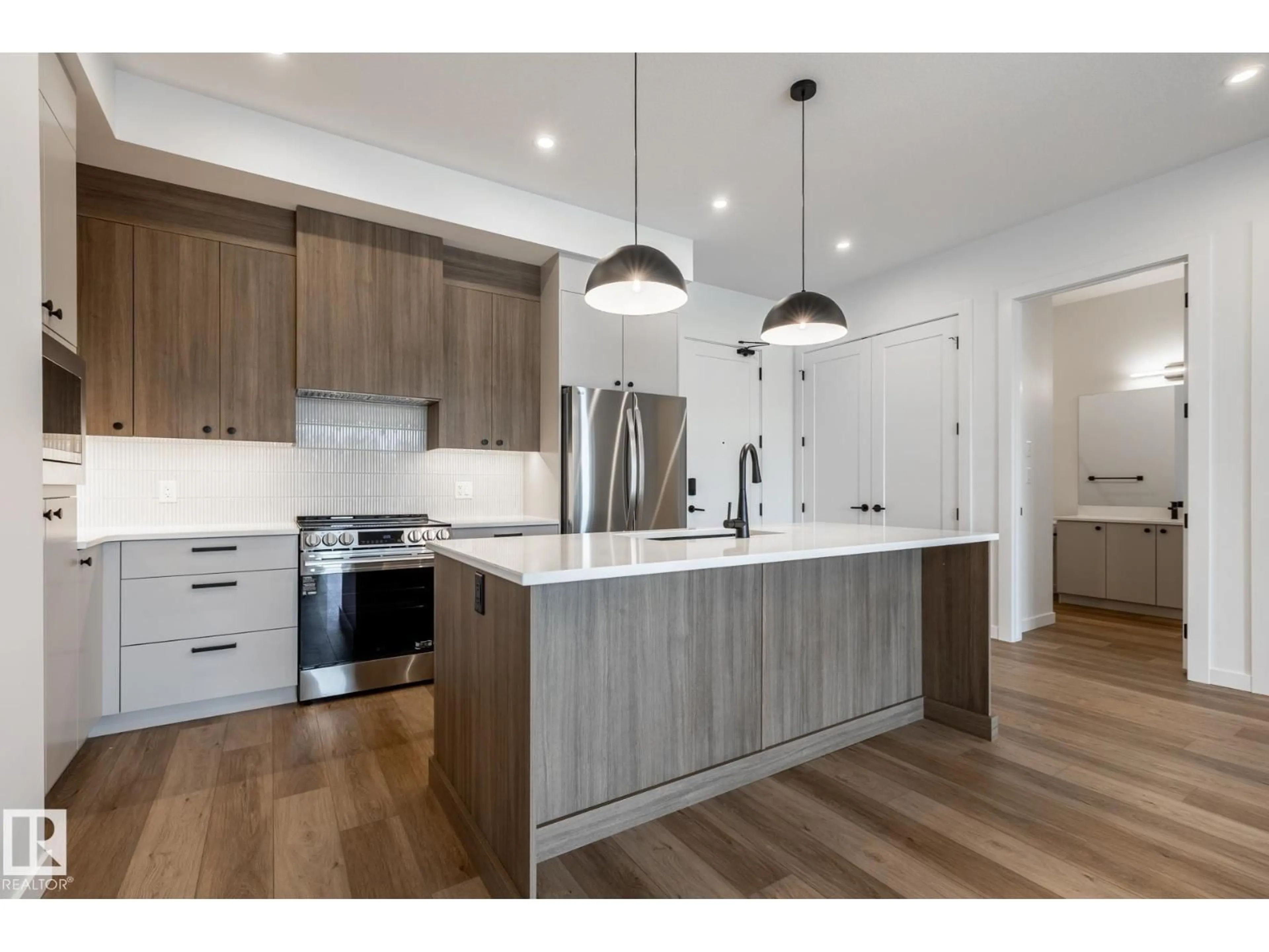Open concept kitchen, wood/laminate floor for #418 - 7459 MAY COMMON, Edmonton Alberta T6R0X6