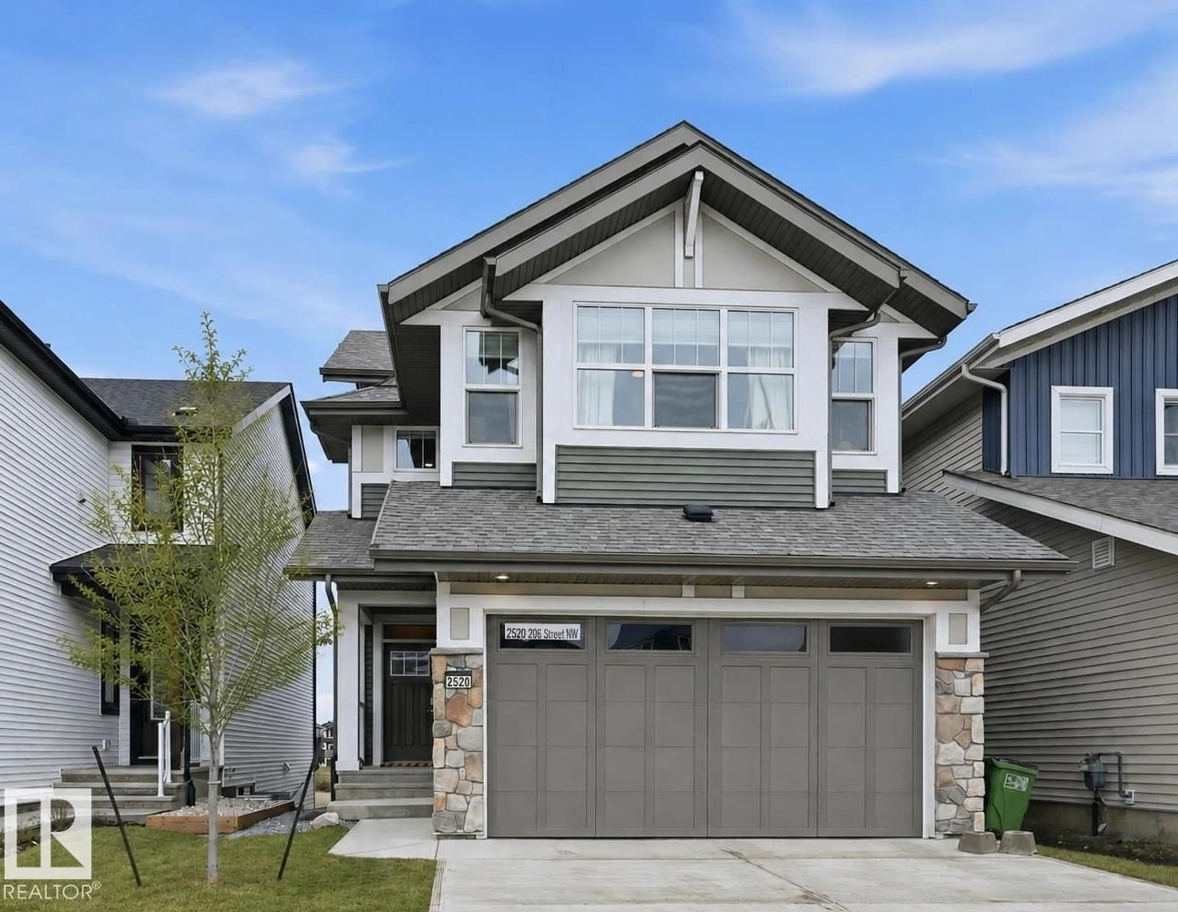 Home with vinyl exterior material, street for 2520 206 ST, Edmonton Alberta T6M1P1