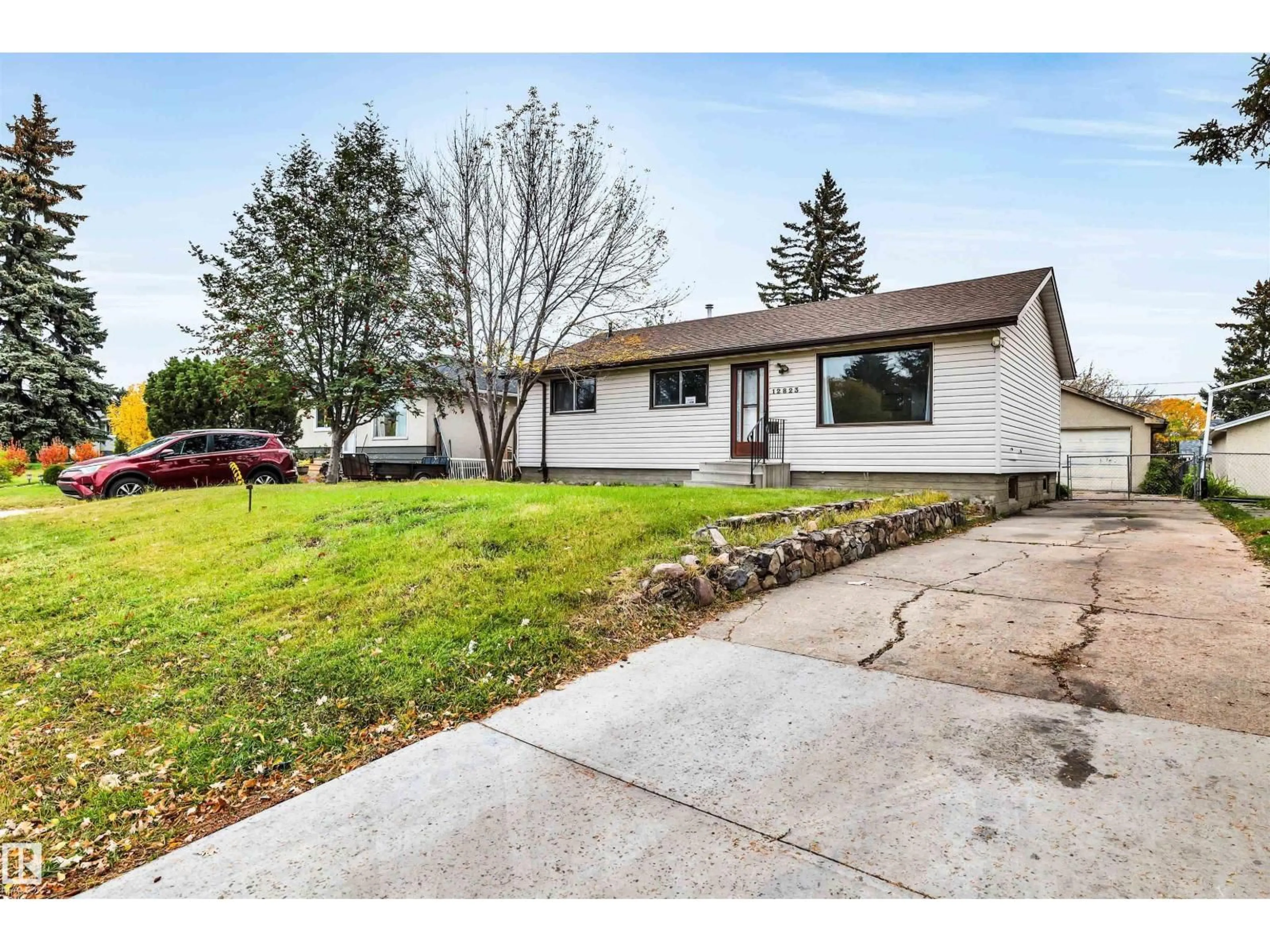 Home with vinyl exterior material, street for 12823 94 ST, Edmonton Alberta T5E3V6
