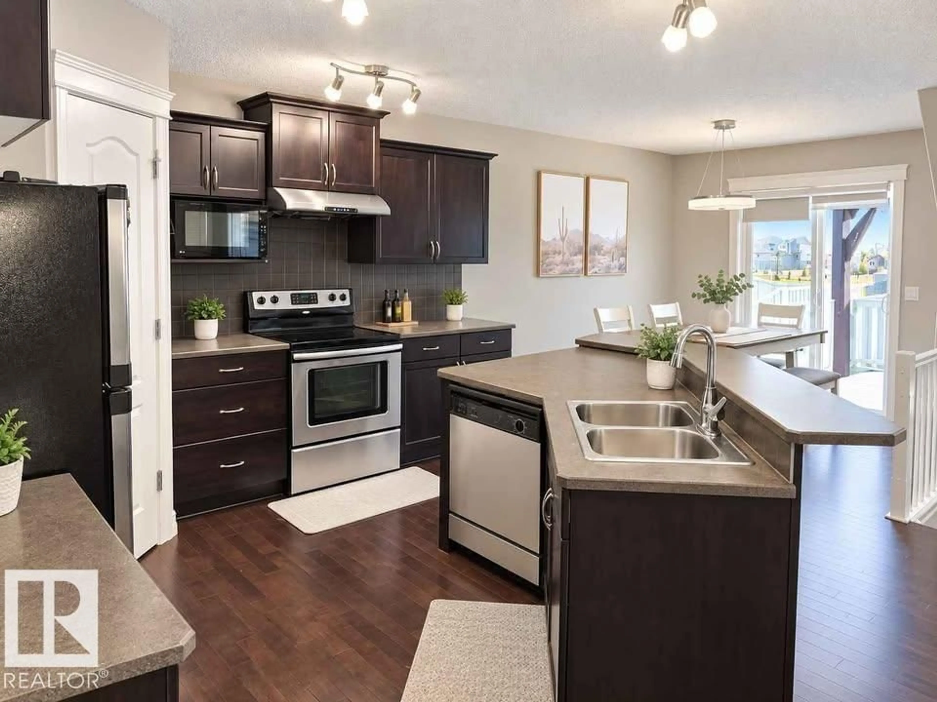 Open concept kitchen, wood/laminate floor for 2628 30 ST, Edmonton Alberta T6T0H6