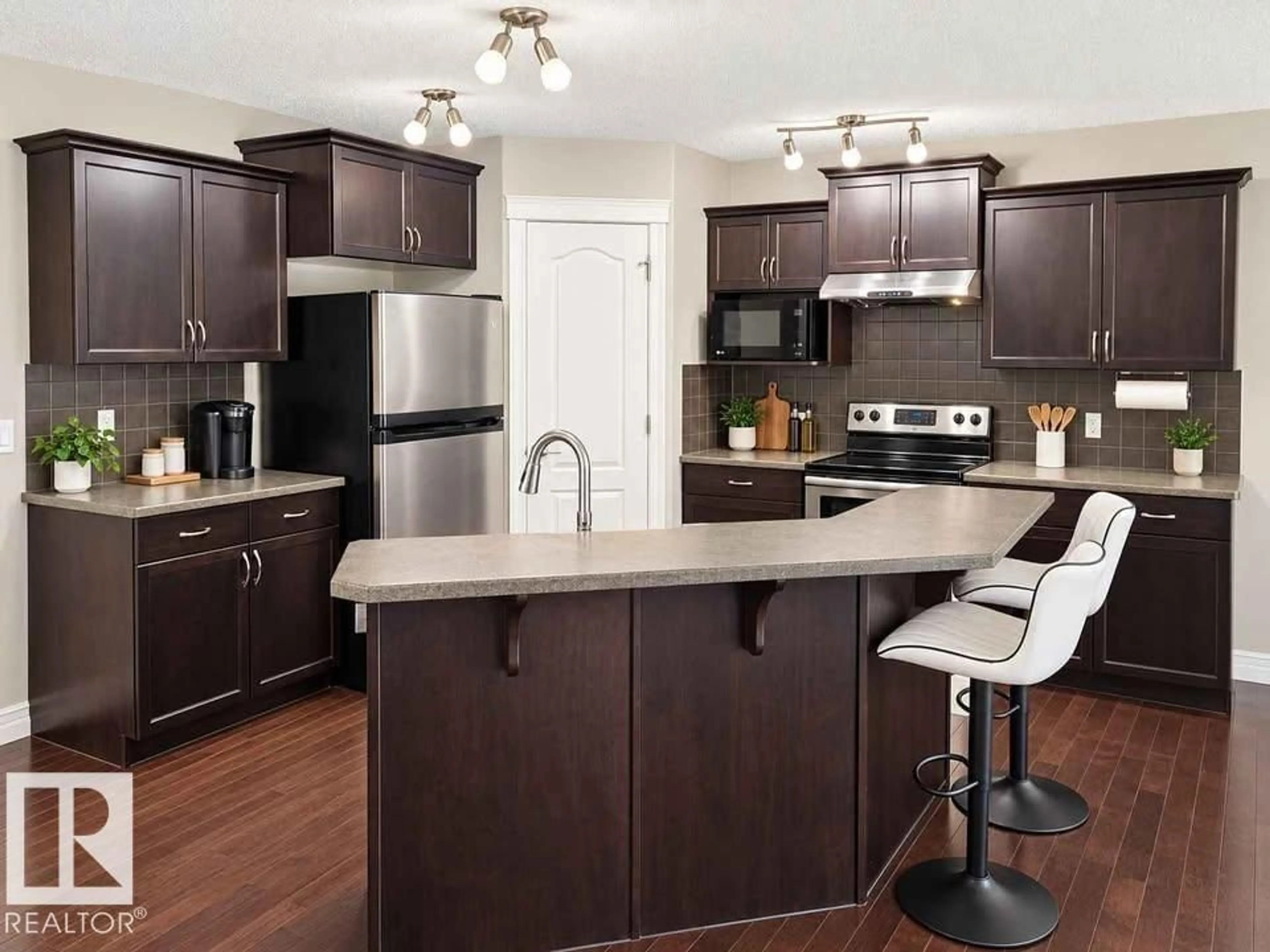 Open concept kitchen, wood/laminate floor for 2628 30 ST, Edmonton Alberta T6T0H6
