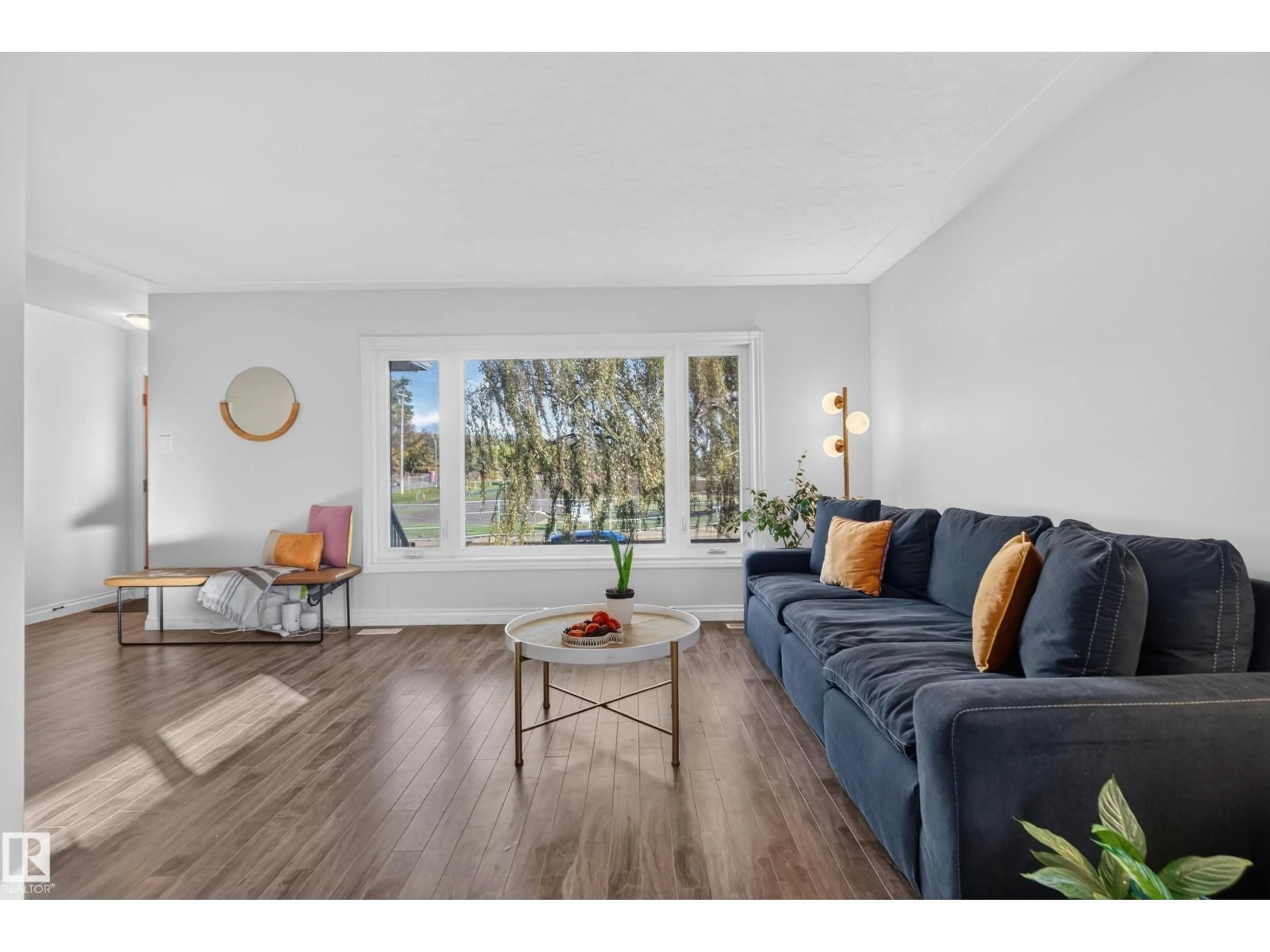 Living room with furniture, wood/laminate floor for 9814 79 ST, Edmonton Alberta T6A3G1