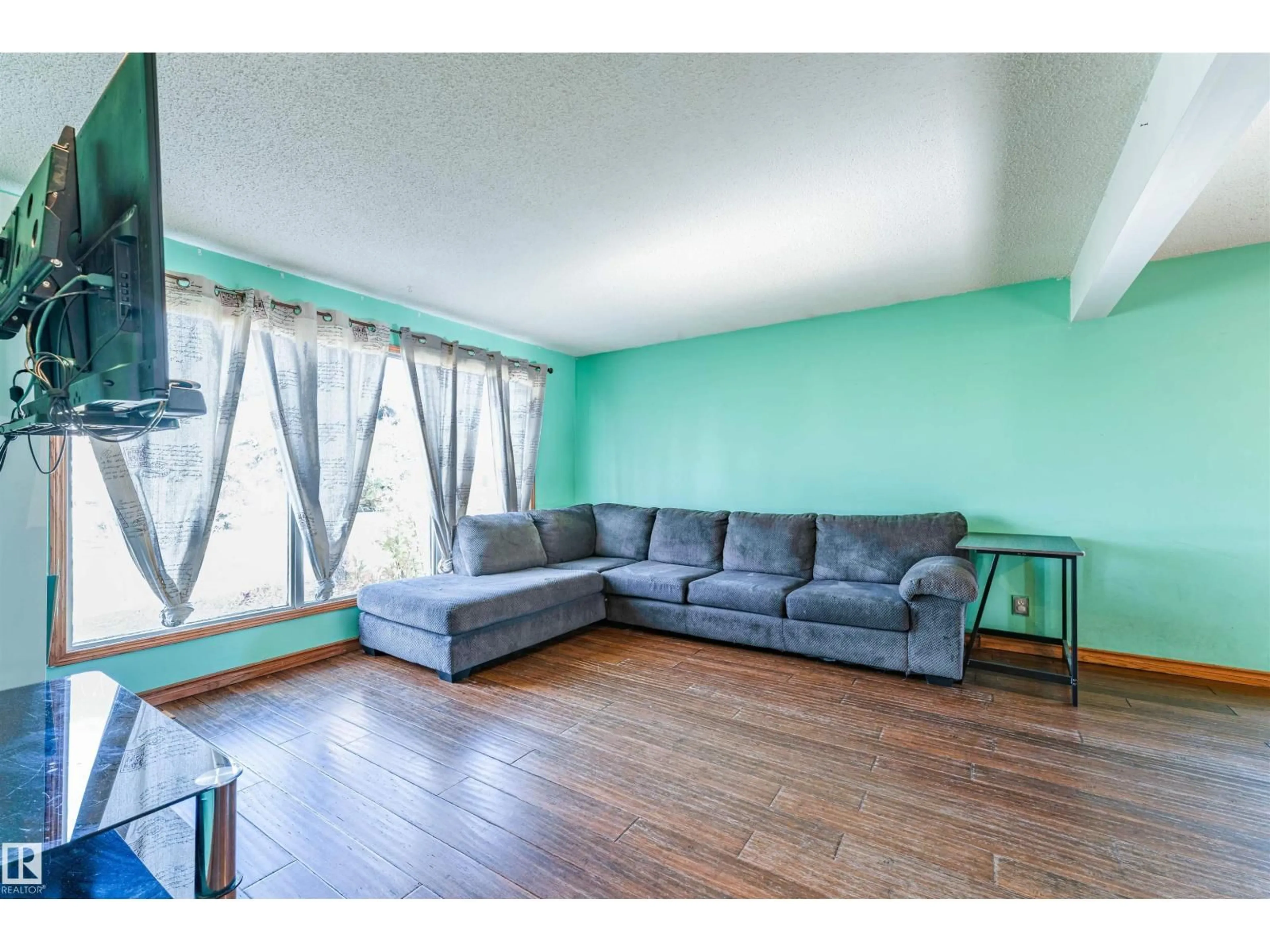 Living room with furniture, wood/laminate floor for 113 GREENWOOD DR, Spruce Grove Alberta T7X1X8