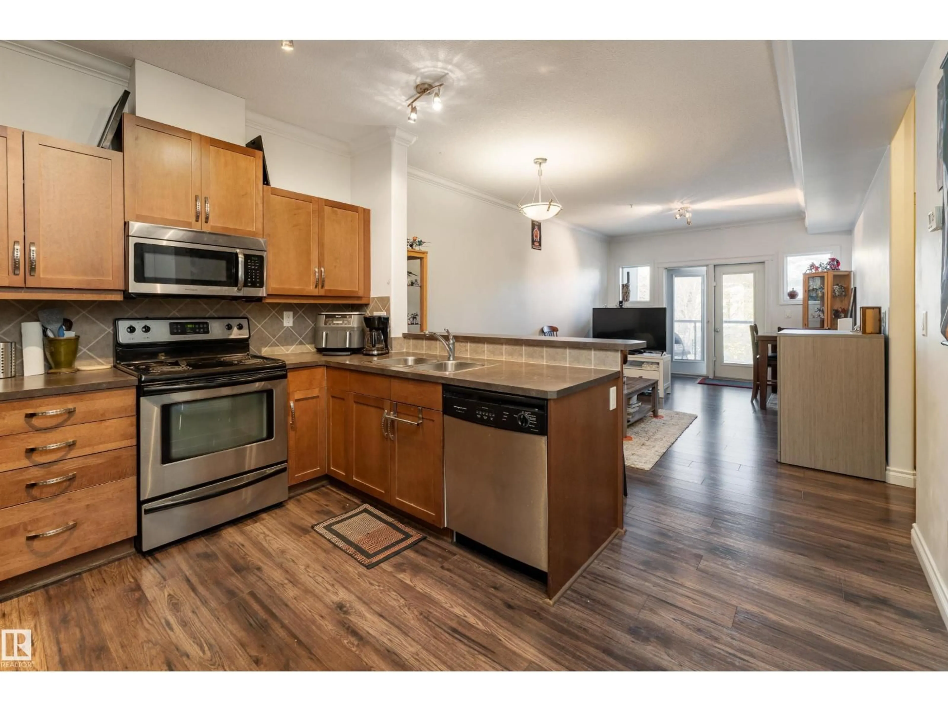 Open concept kitchen, wood/laminate floor for #211 - 10121 80 AV, Edmonton Alberta T6E0B9
