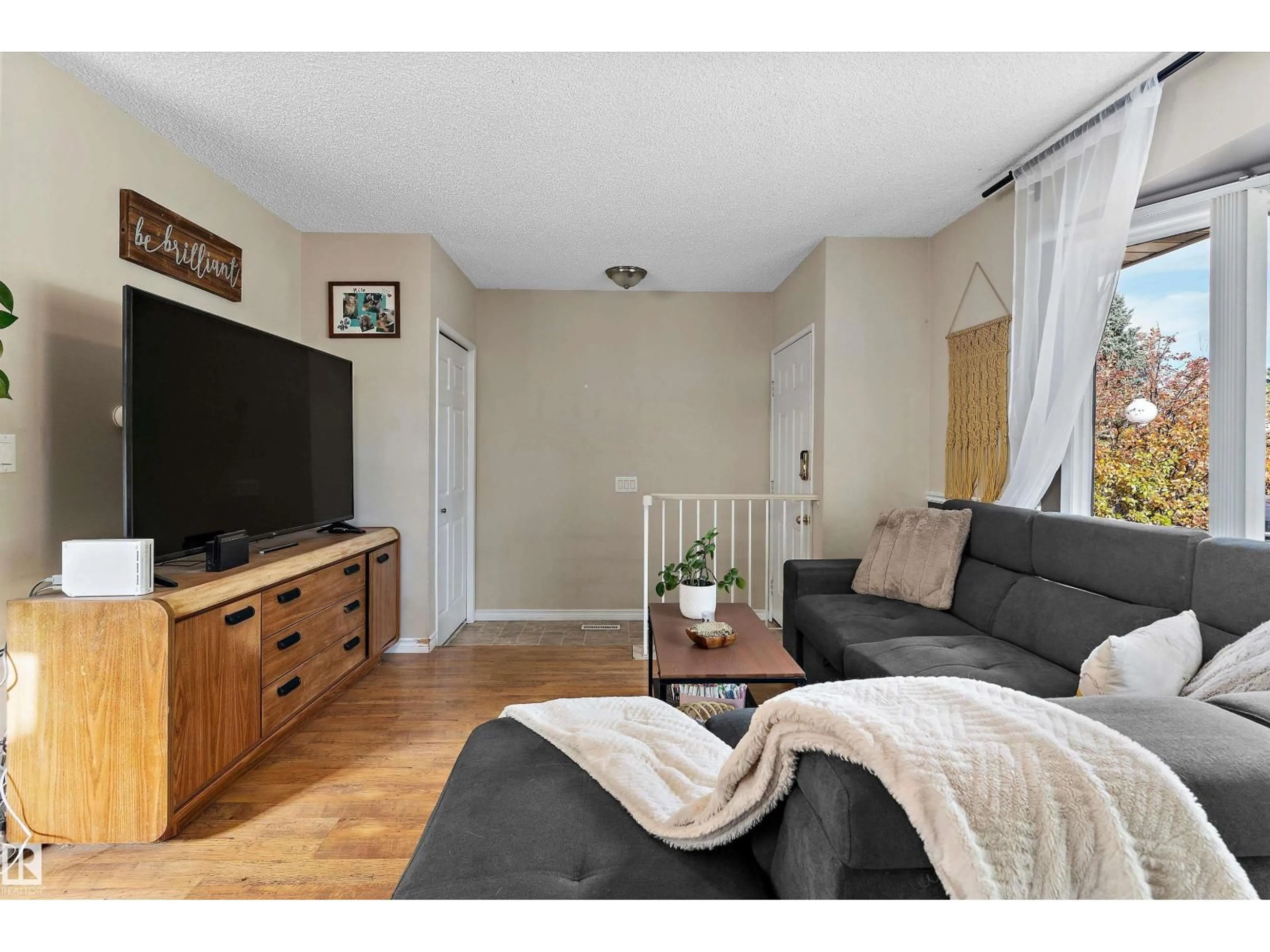Living room with furniture, wood/laminate floor for 5406 55 ST, Beaumont Alberta T4X1A4