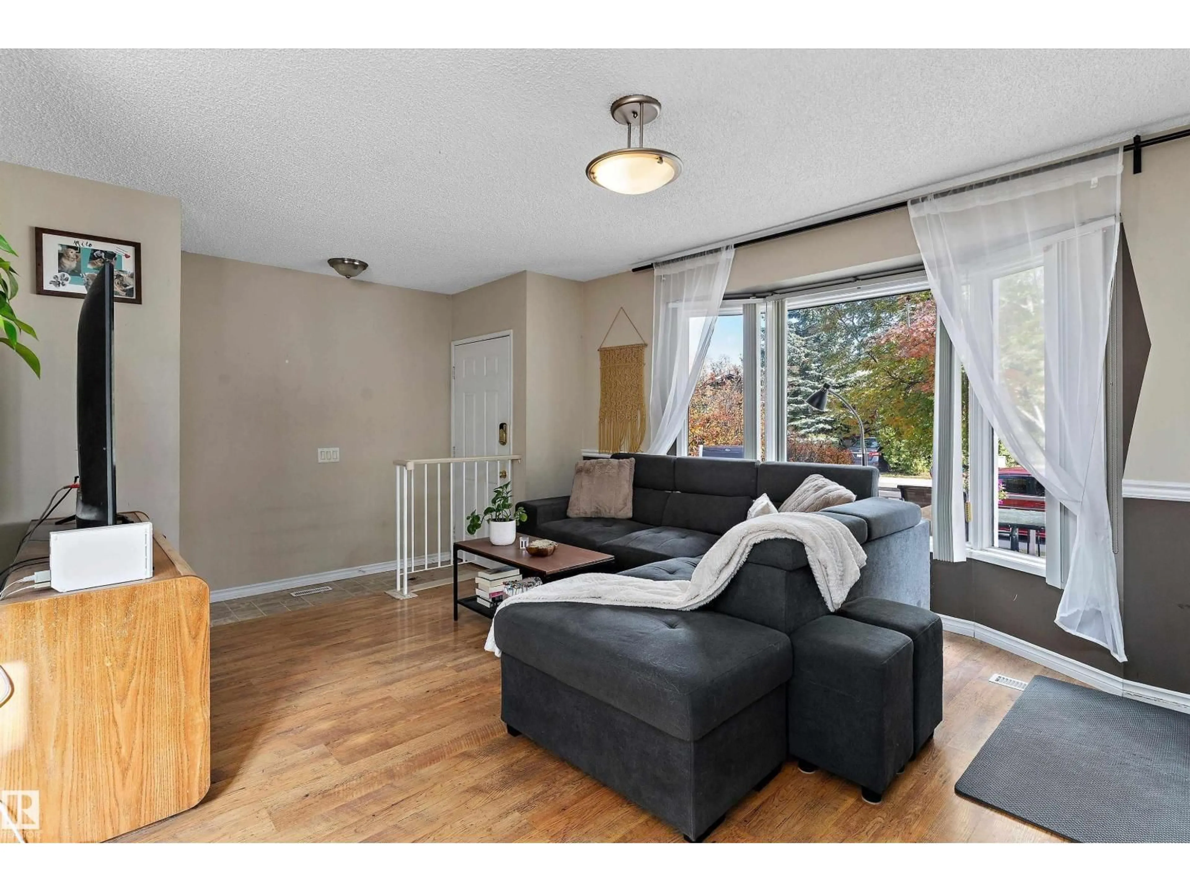 Living room with furniture, wood/laminate floor for 5406 55 ST, Beaumont Alberta T4X1A4