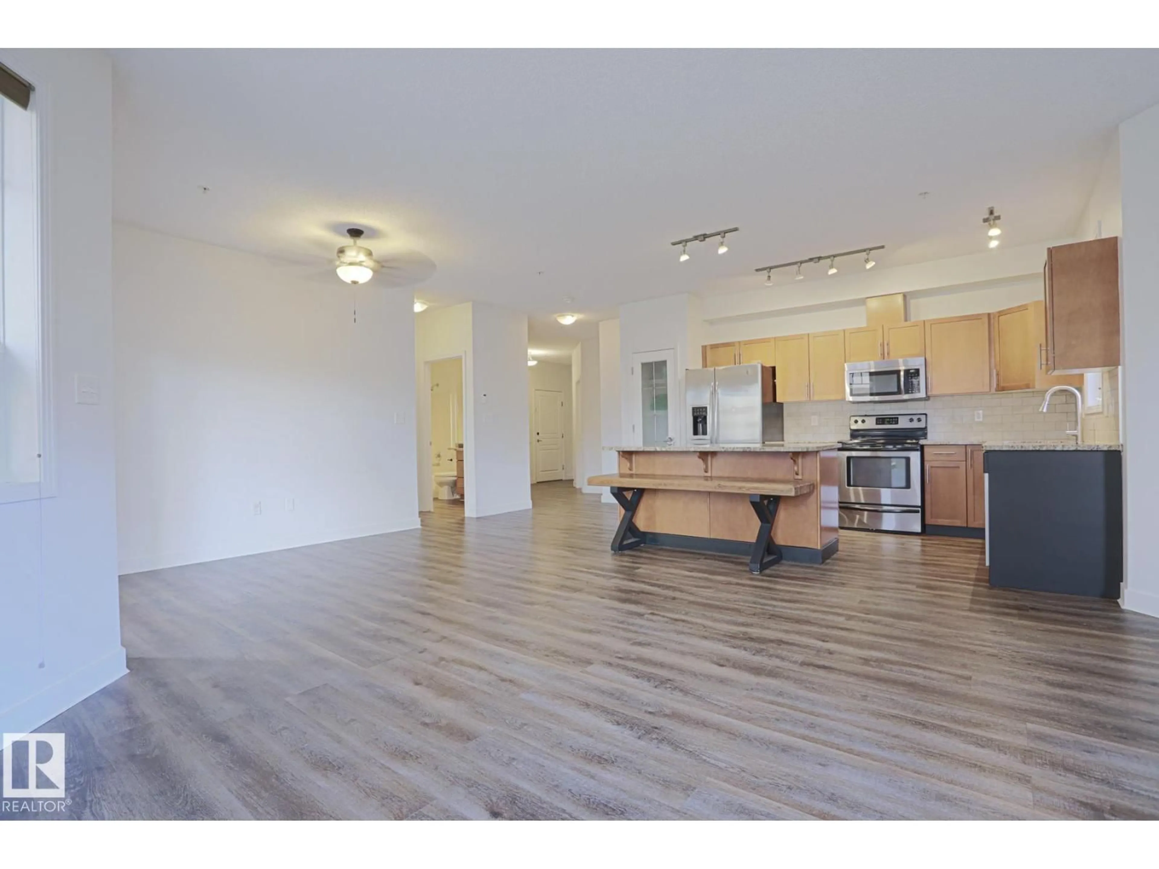 Open concept kitchen, wood/laminate floor for #111 - 2035 GRANTHAM CO, Edmonton Alberta T5T3X4