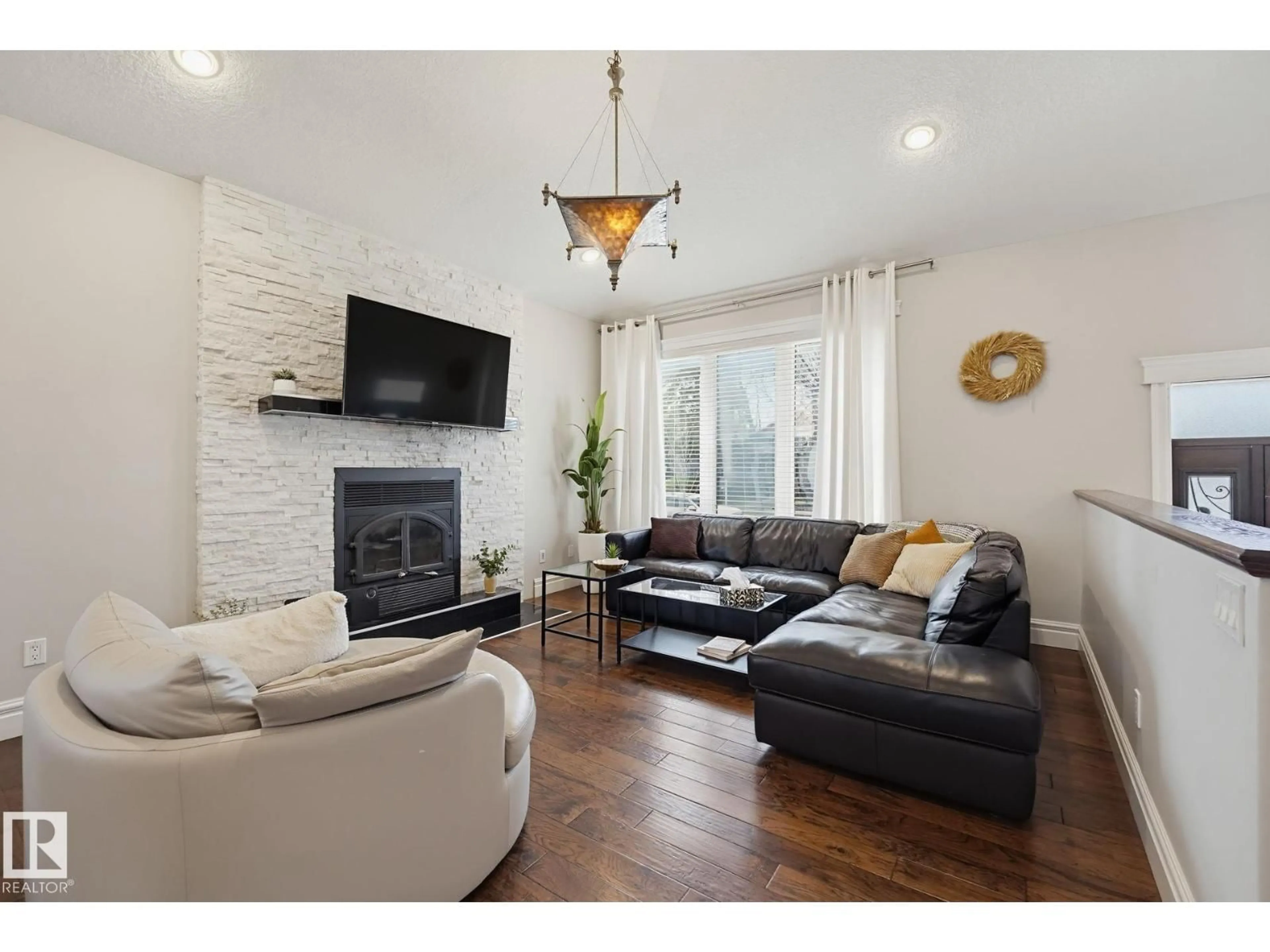 Living room with furniture, wood/laminate floor for 10351 147 ST, Edmonton Alberta T5N3C2