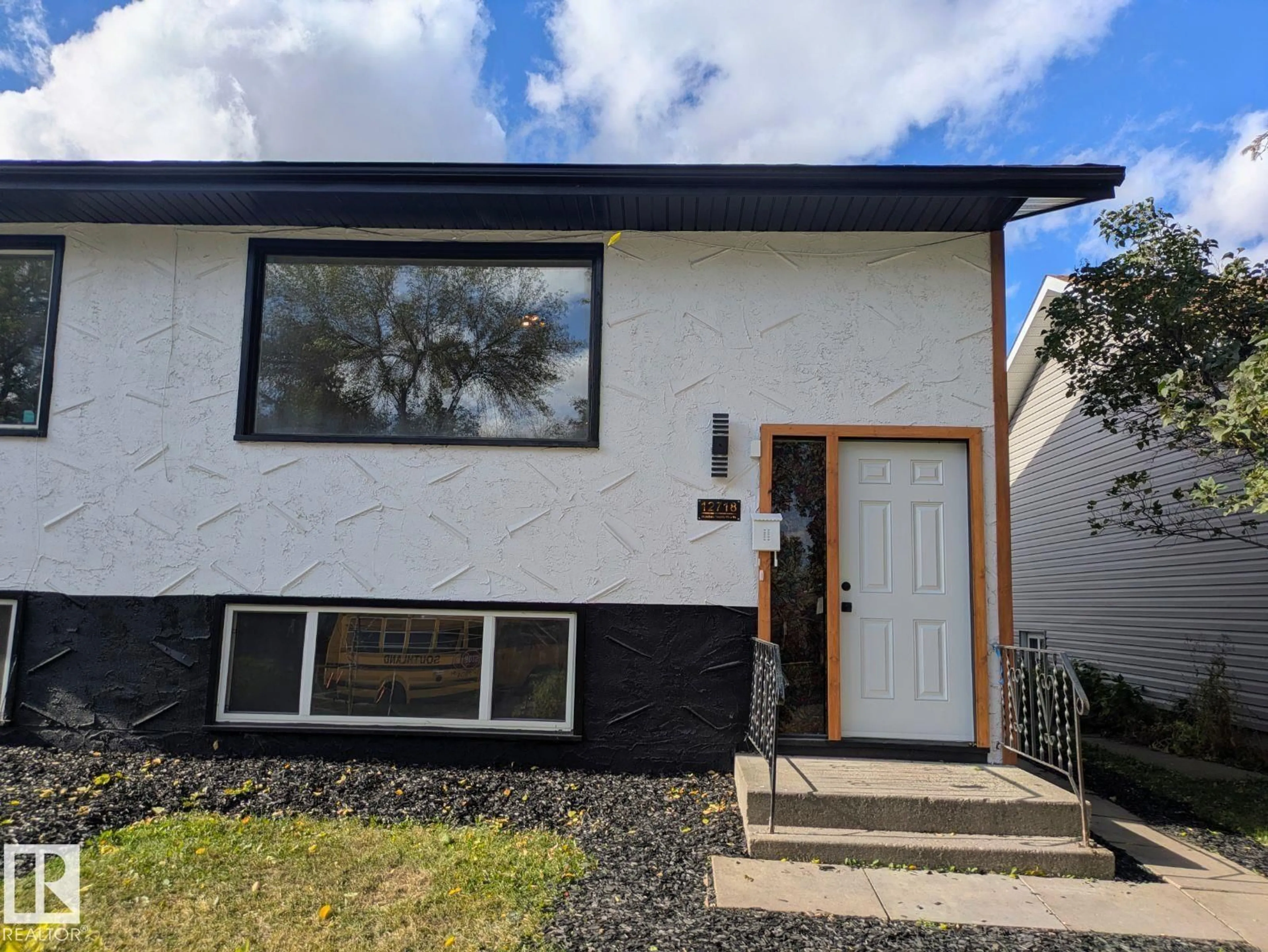 Home with vinyl exterior material, street for 12716 125 ST, Edmonton Alberta T5L0T7