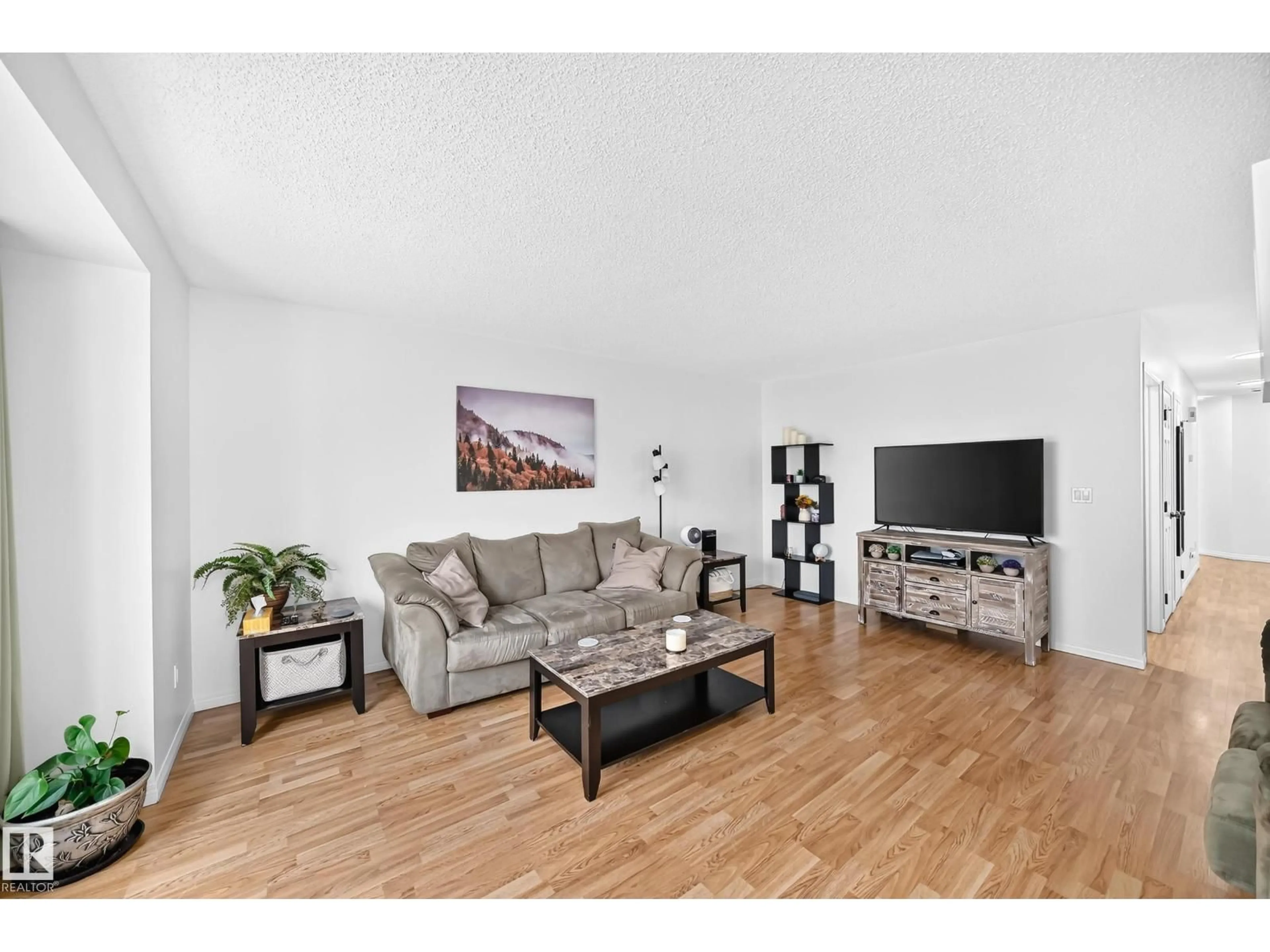Living room with furniture, wood/laminate floor for 10015B 97 AV, Fort Saskatchewan Alberta T8L1R3