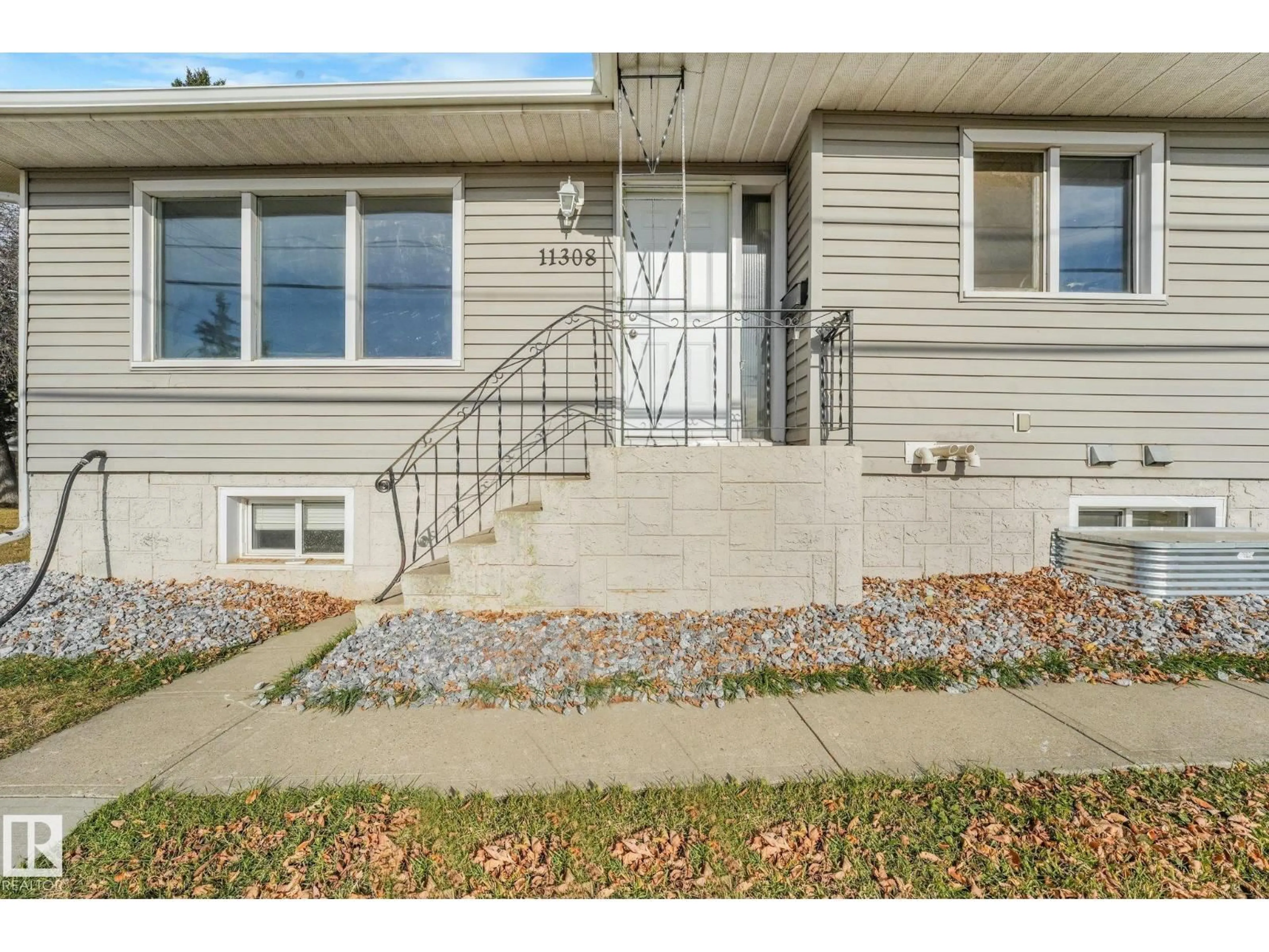 Home with vinyl exterior material, street for 11308 129 AV, Edmonton Alberta T5E0L8