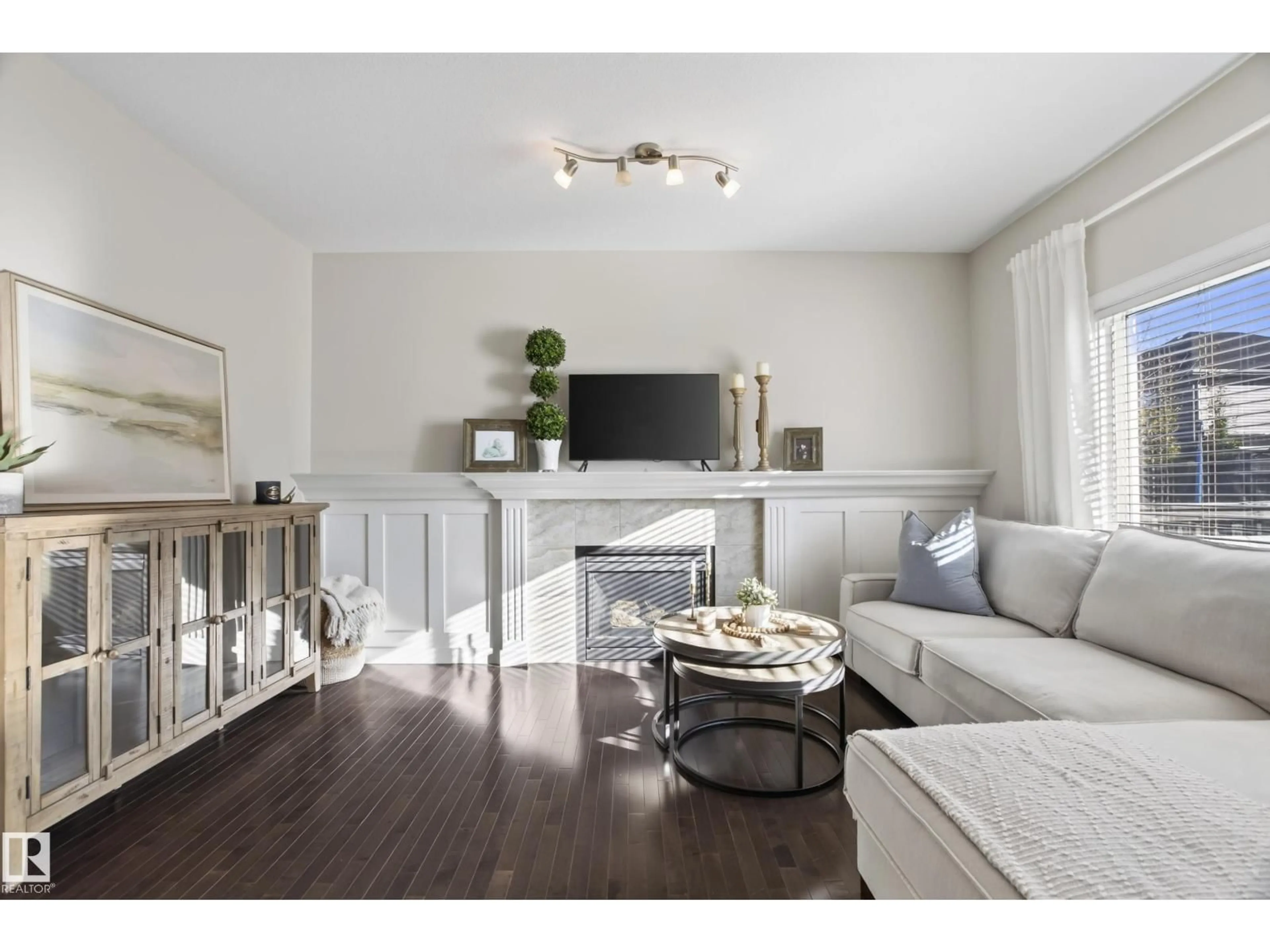 Living room with furniture, wood/laminate floor for 9609 83 AV, Morinville Alberta T8R0A6