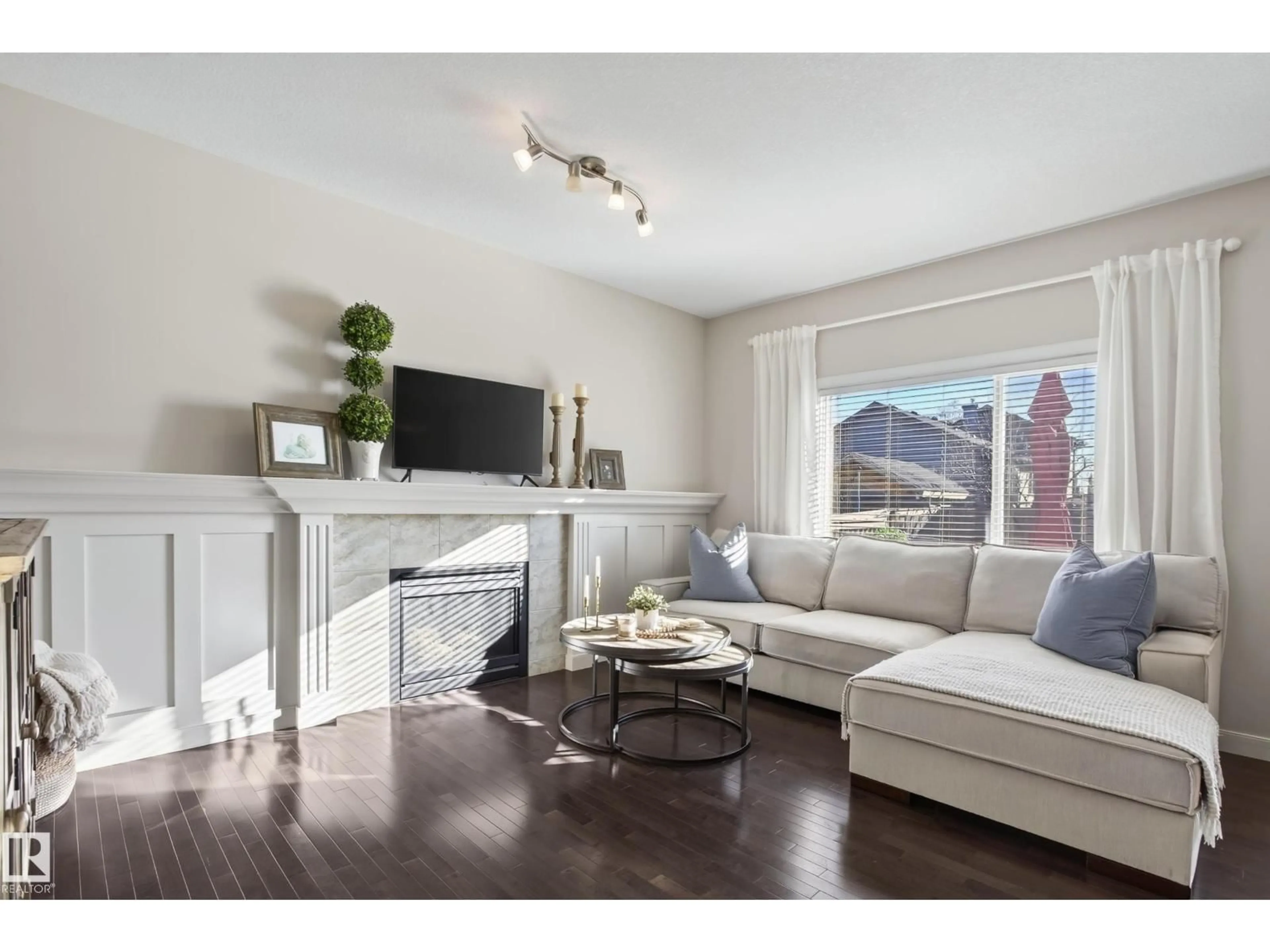 Living room with furniture, wood/laminate floor for 9609 83 AV, Morinville Alberta T8R0A6