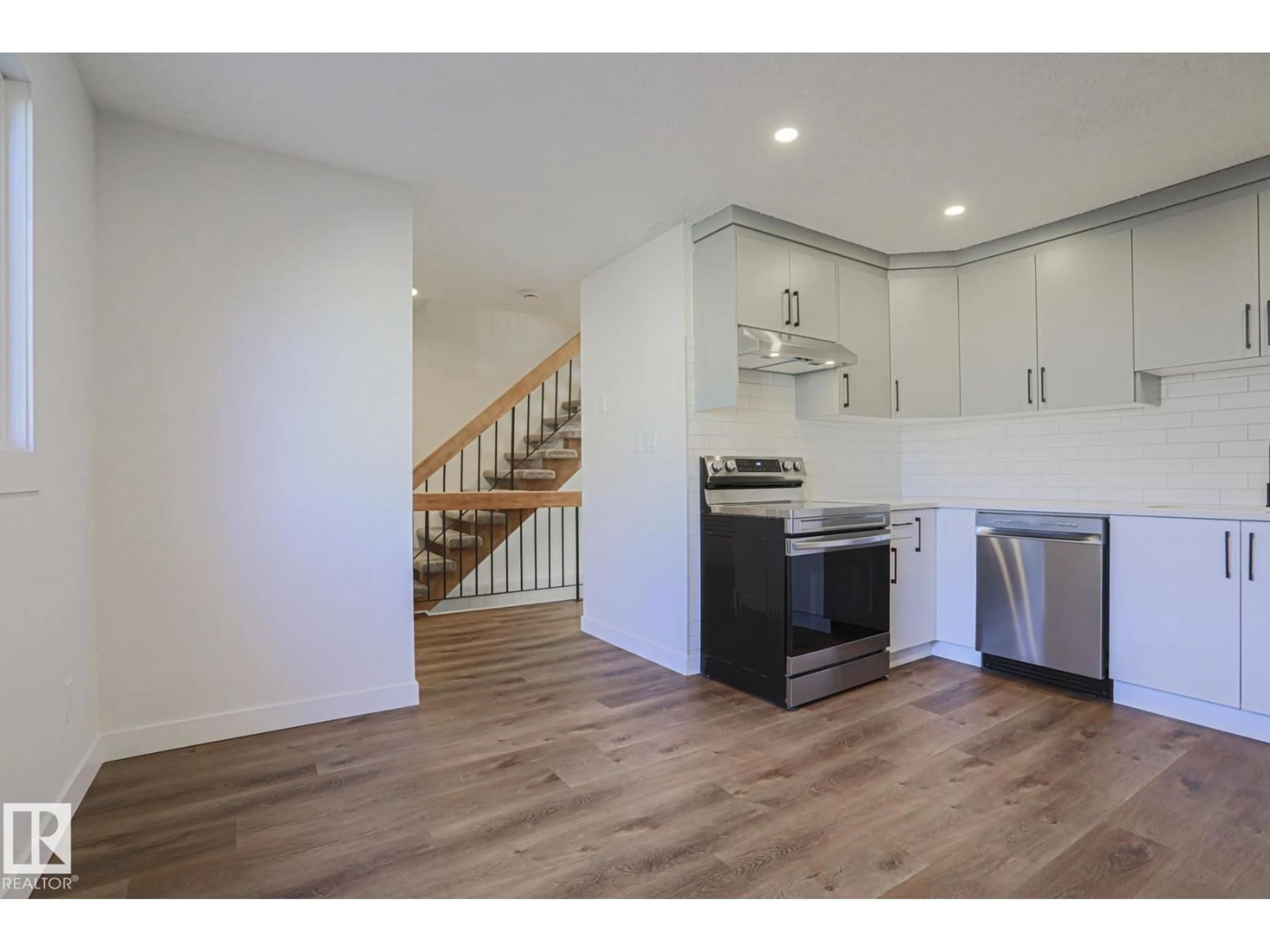 Open concept kitchen, wood/laminate floor for NW - 3237 132A AV, Edmonton Alberta T5A3K4