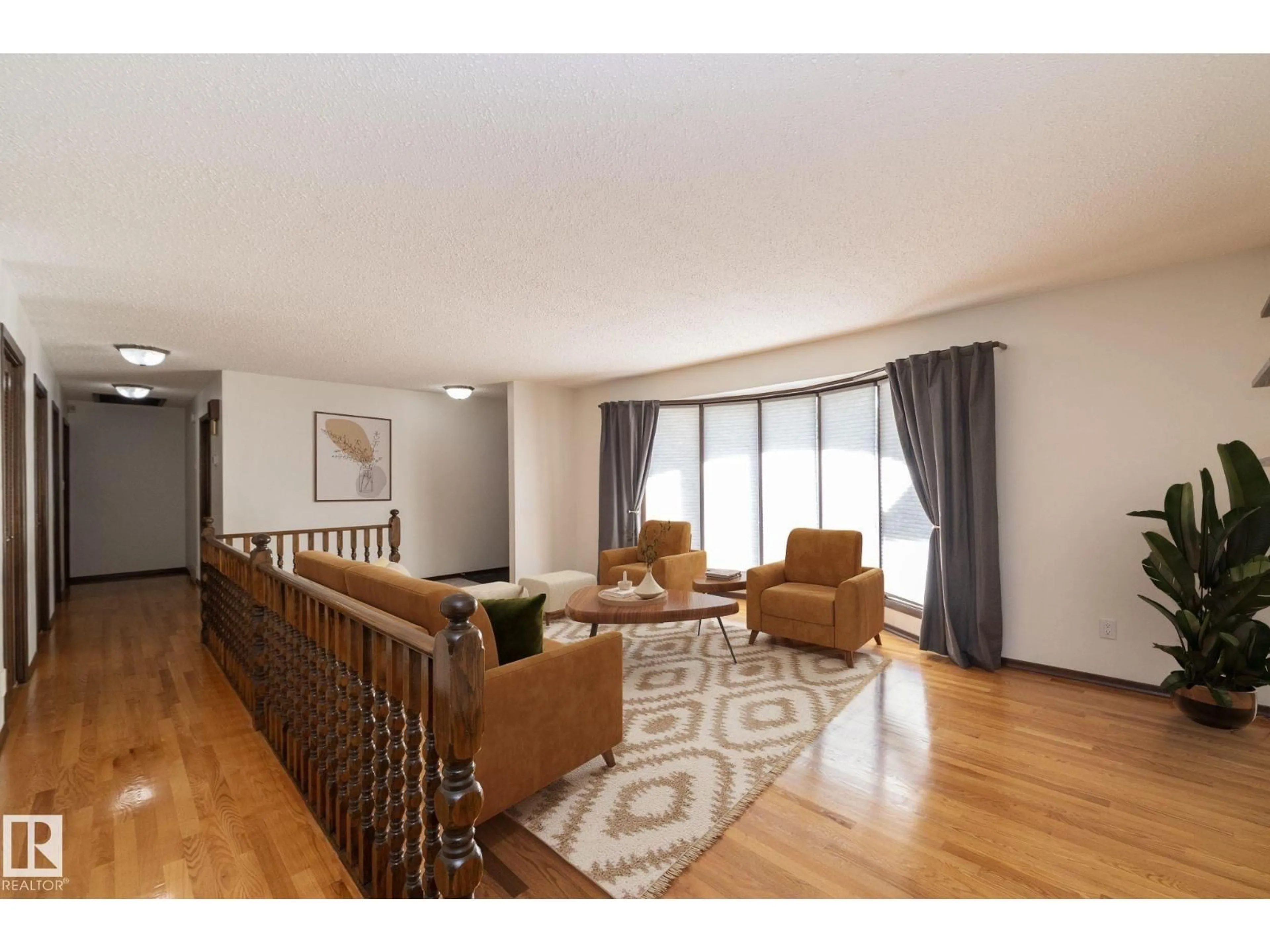 Living room with furniture, wood/laminate floor for 18412 82 AV, Edmonton Alberta T5T3K4