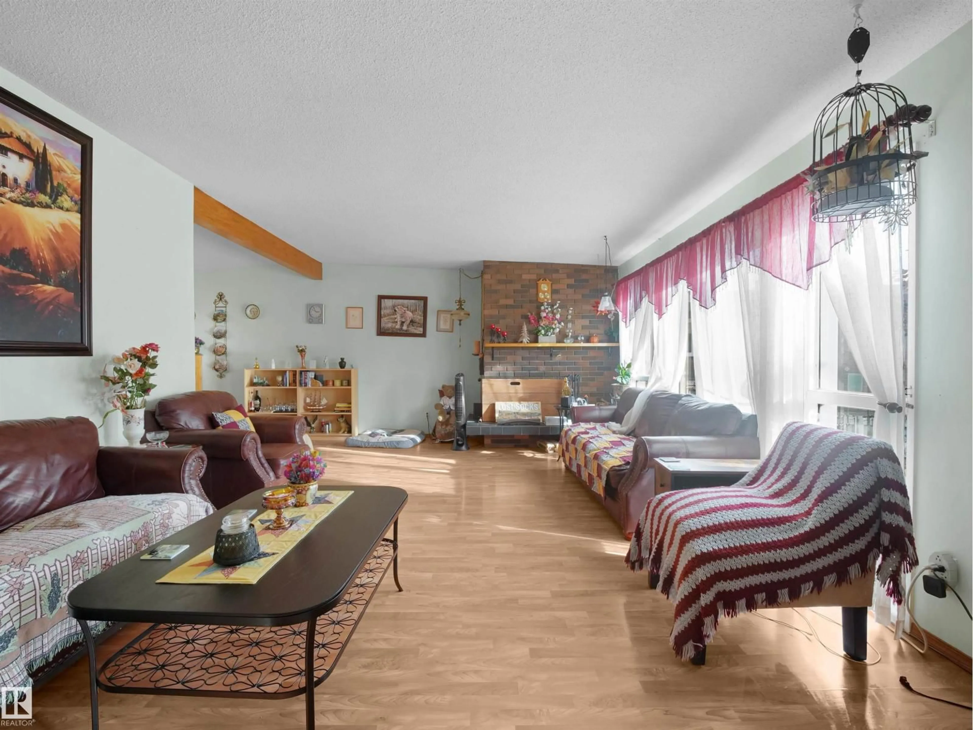 Living room with furniture, wood/laminate floor for 17108 82 AV, Edmonton Alberta T5T0C1