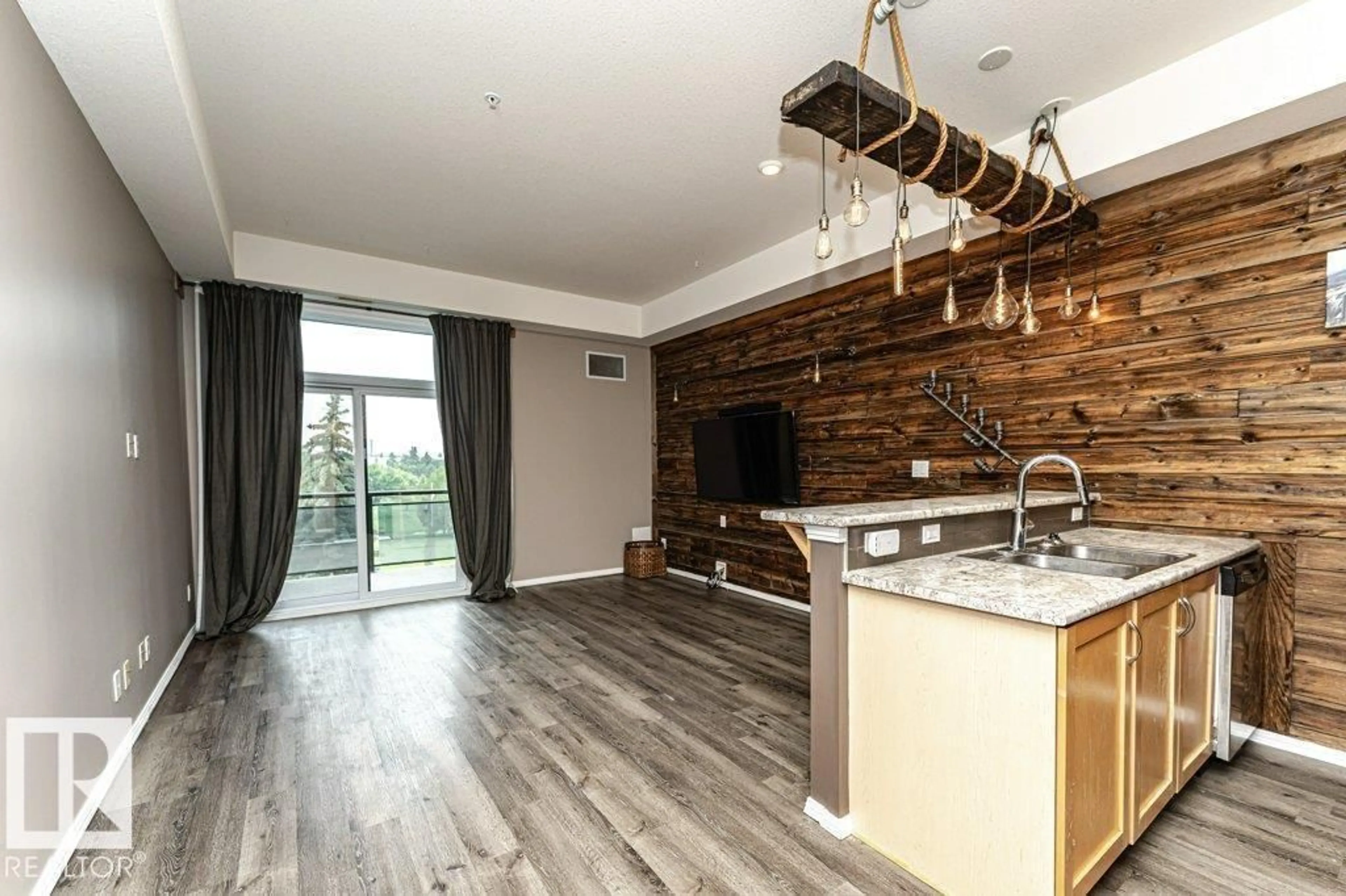 Open concept kitchen, wood/laminate floor for #404 - 10531 117 ST, Edmonton Alberta T5H0A8