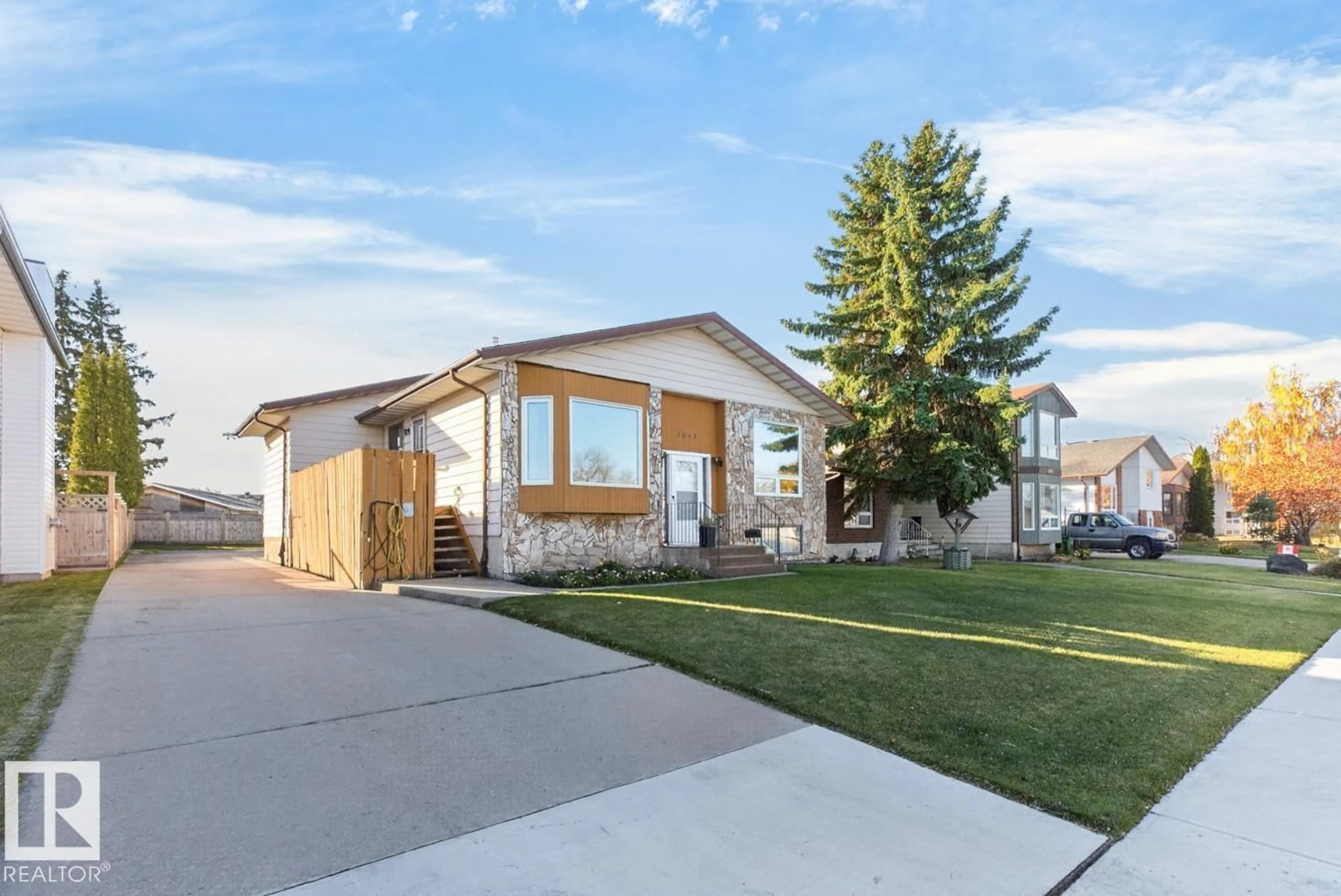 Home with vinyl exterior material, street for 3047 143 AV, Edmonton Alberta T5Y1M9